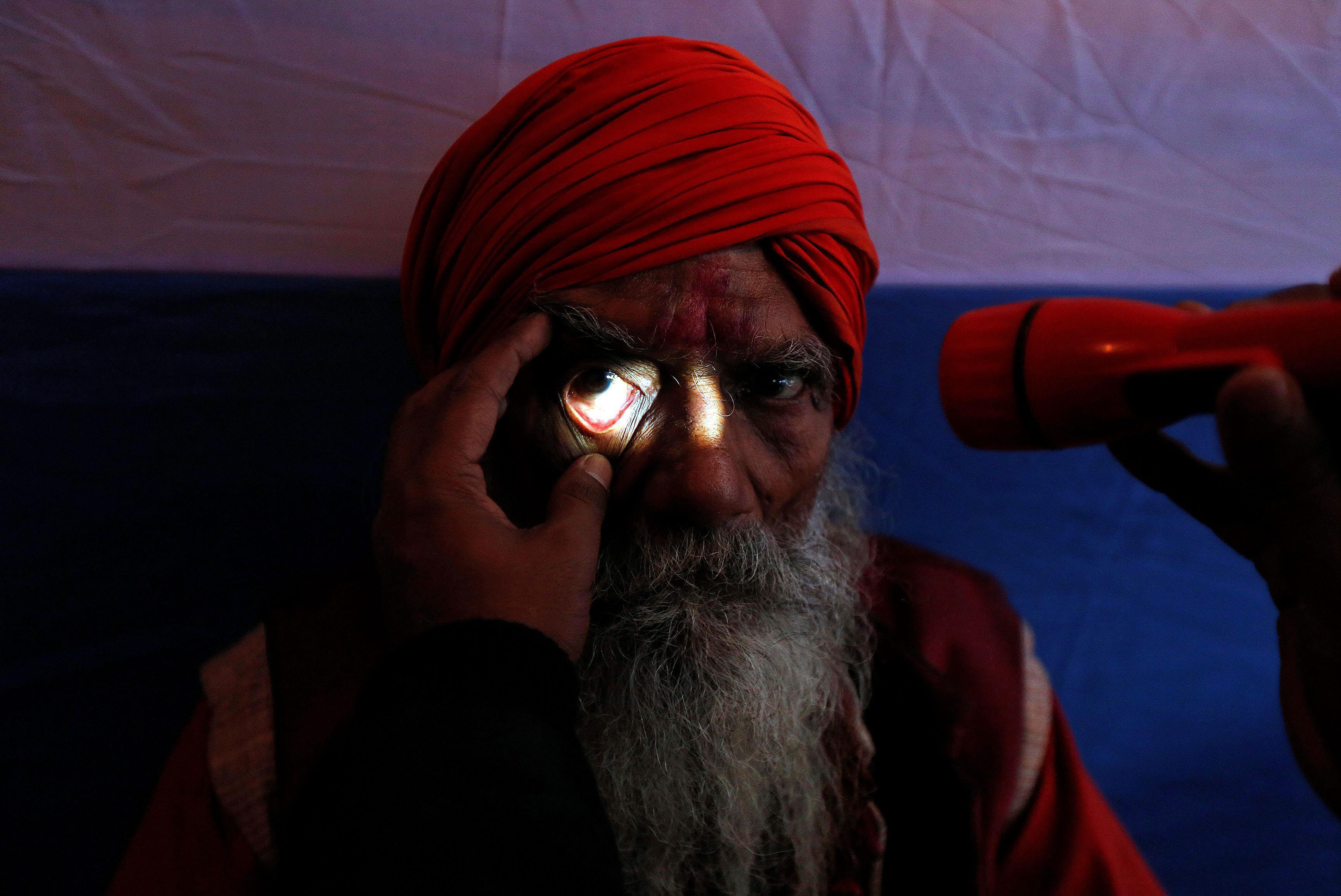A Sadhu or a Hindu holy man undergoes an eye examination at a free eye-care camp organised by social