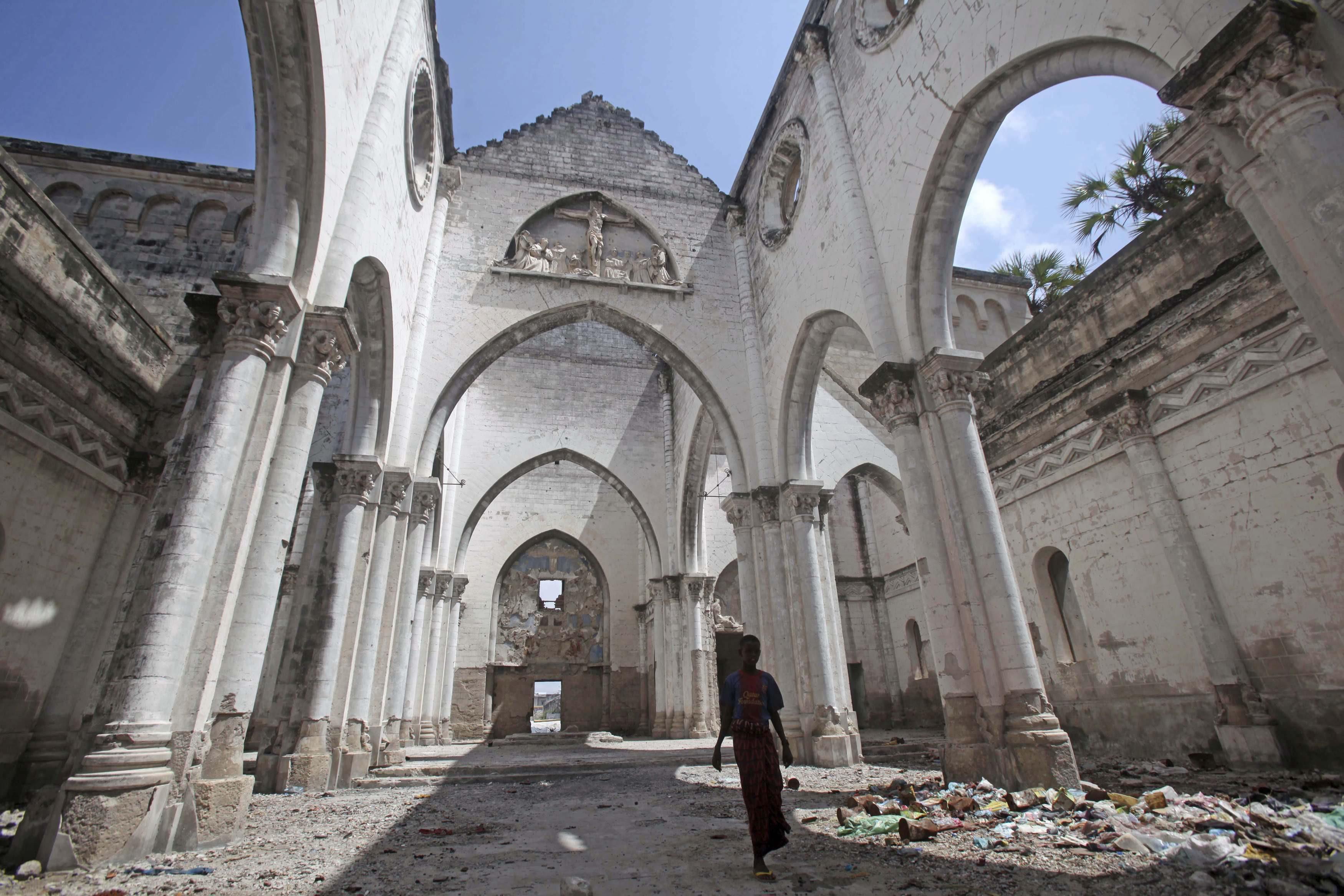 A boy stands inside a destroyed church in the Hamerweyne district of Mogadishu September 26, 2013. S