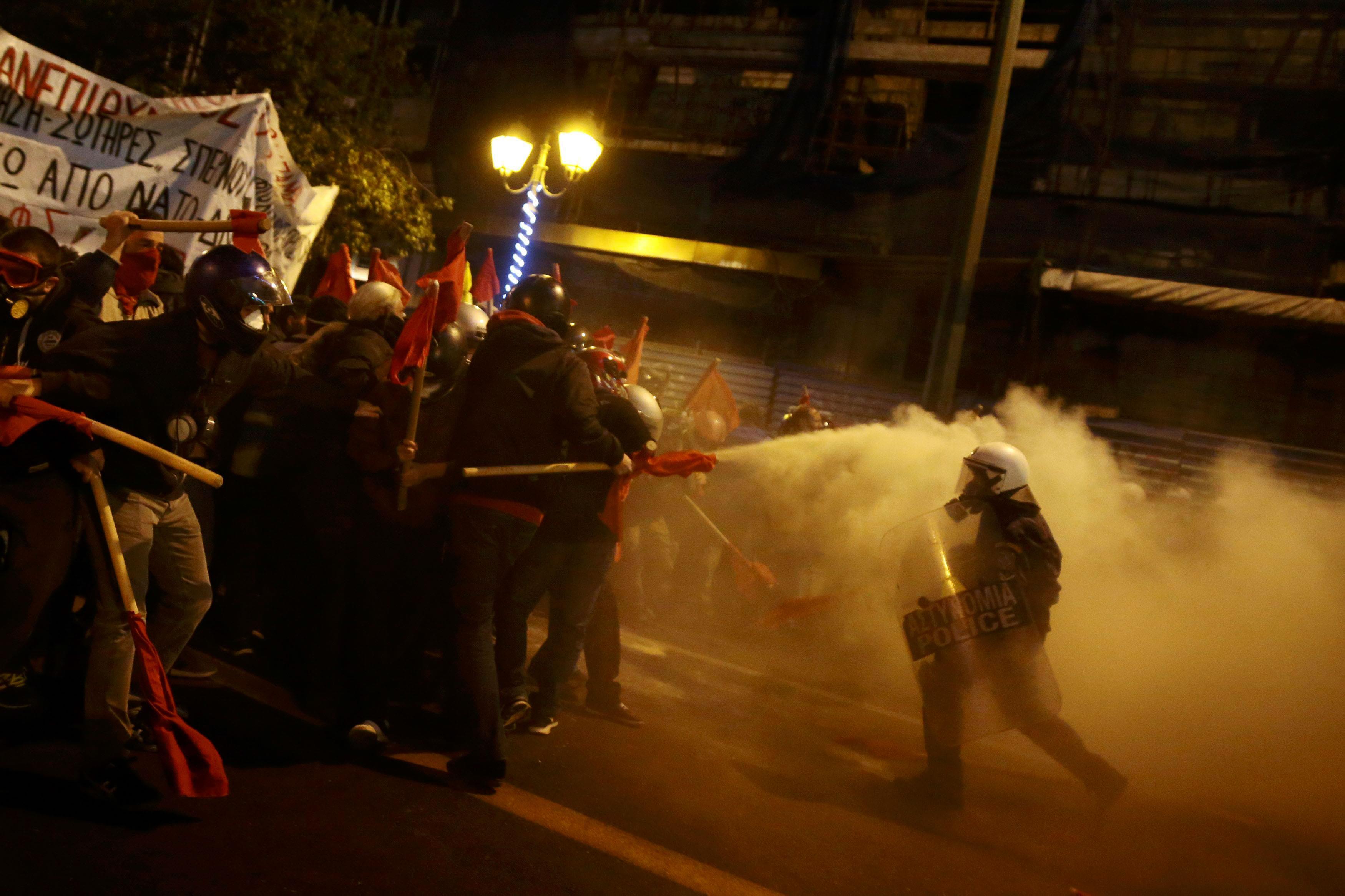 Protesters clash with riot police during a demonstration against the visit of US President Obama in 