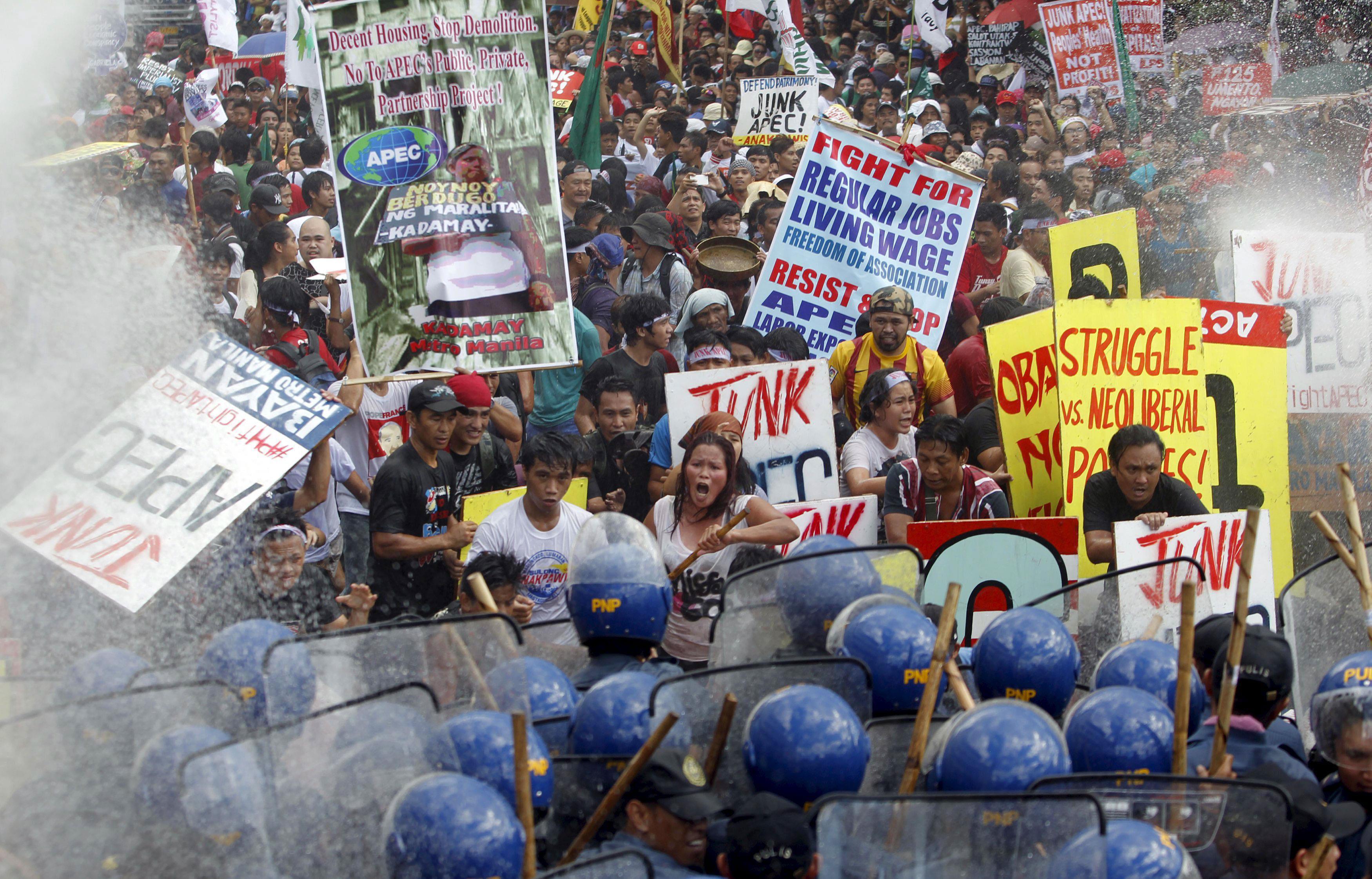 Protesters shout slogans as they march towards the venues of the Asia-Pacific Economic Cooperation (