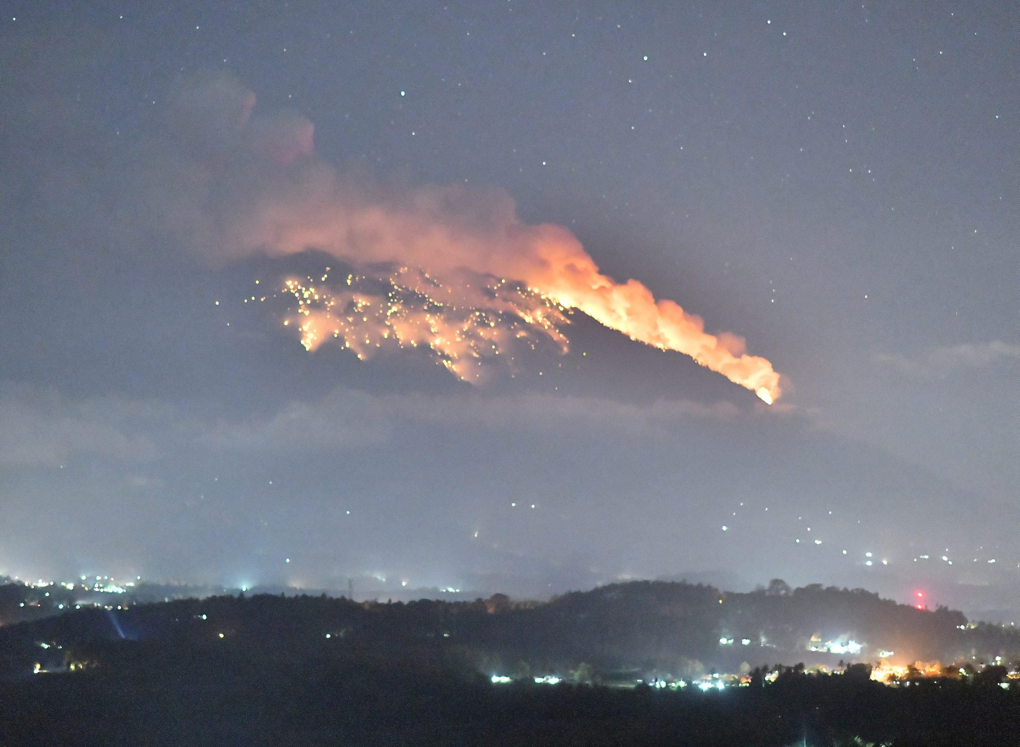 Mount Agung volcano erupts during the night, as seen from Bugbug village in Karangasem regency in Ba