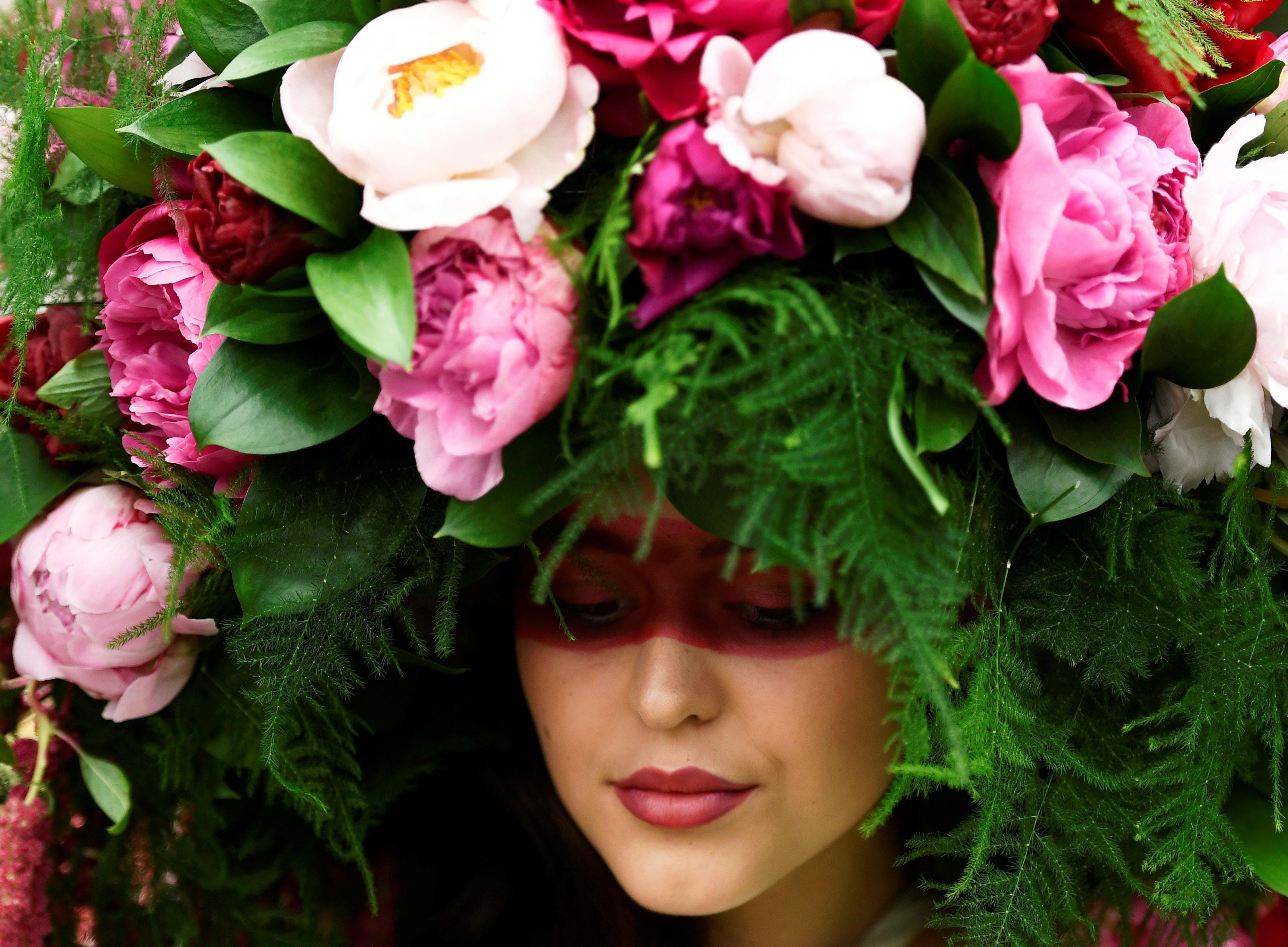 A model wears a floral headdress at the Royal Horticultural Society's Chelsea Flower show in London