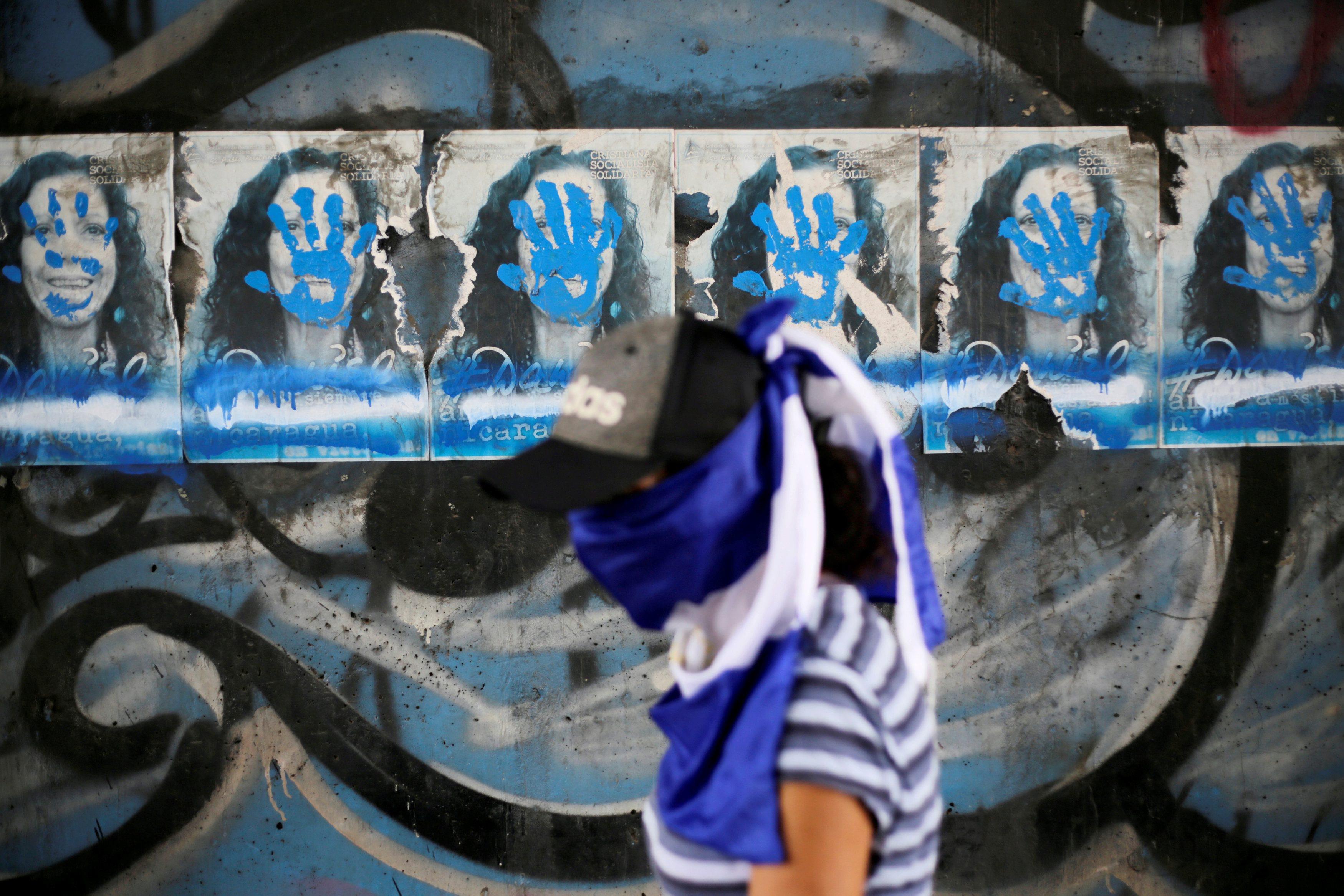 Fliers with images of Nicaragua's Vice President Murillo are seen covered with paint during an anti-