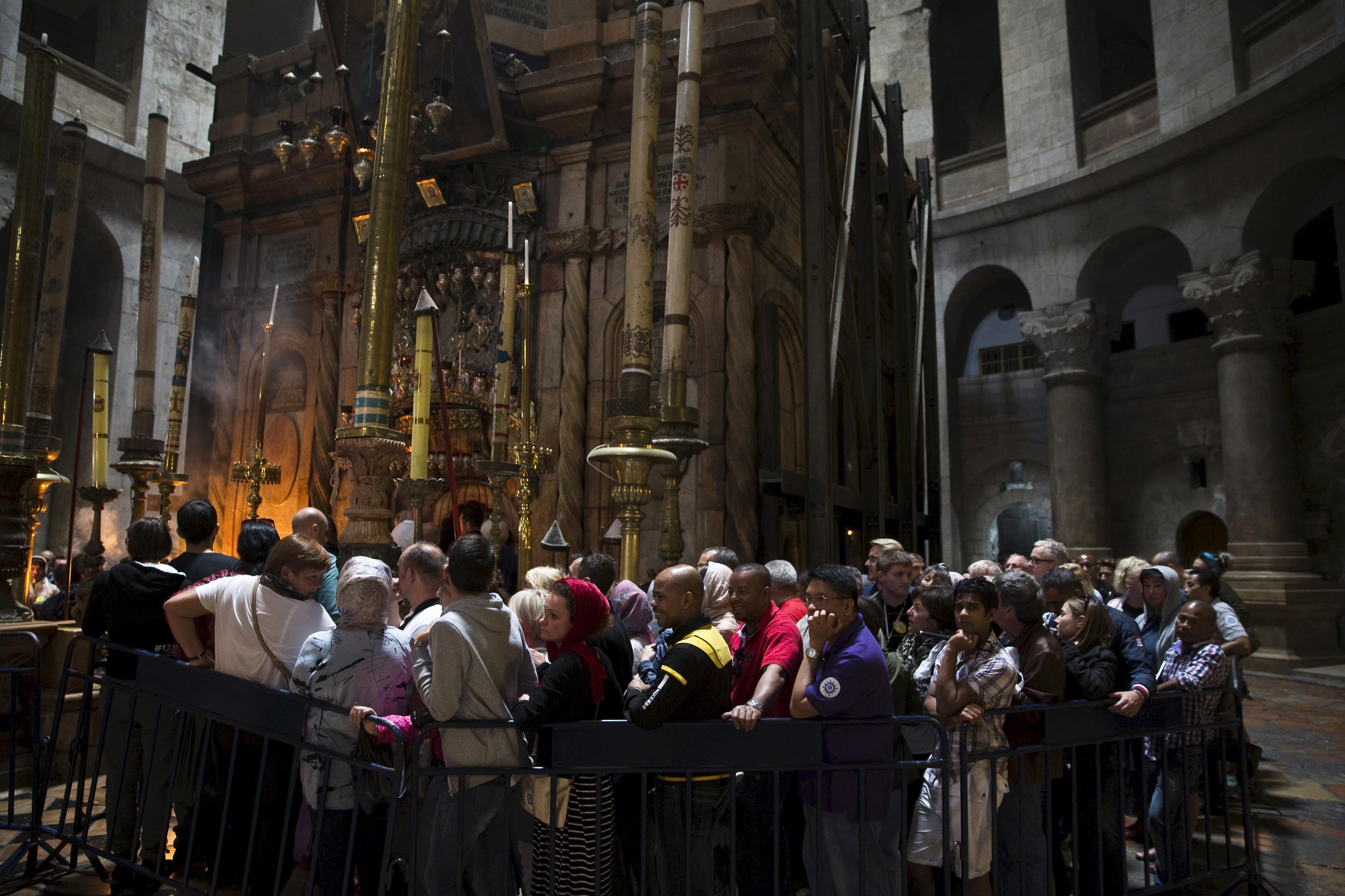 Tourists visit the Church of the Holy Sepulchre in Jerusalem's Old City 