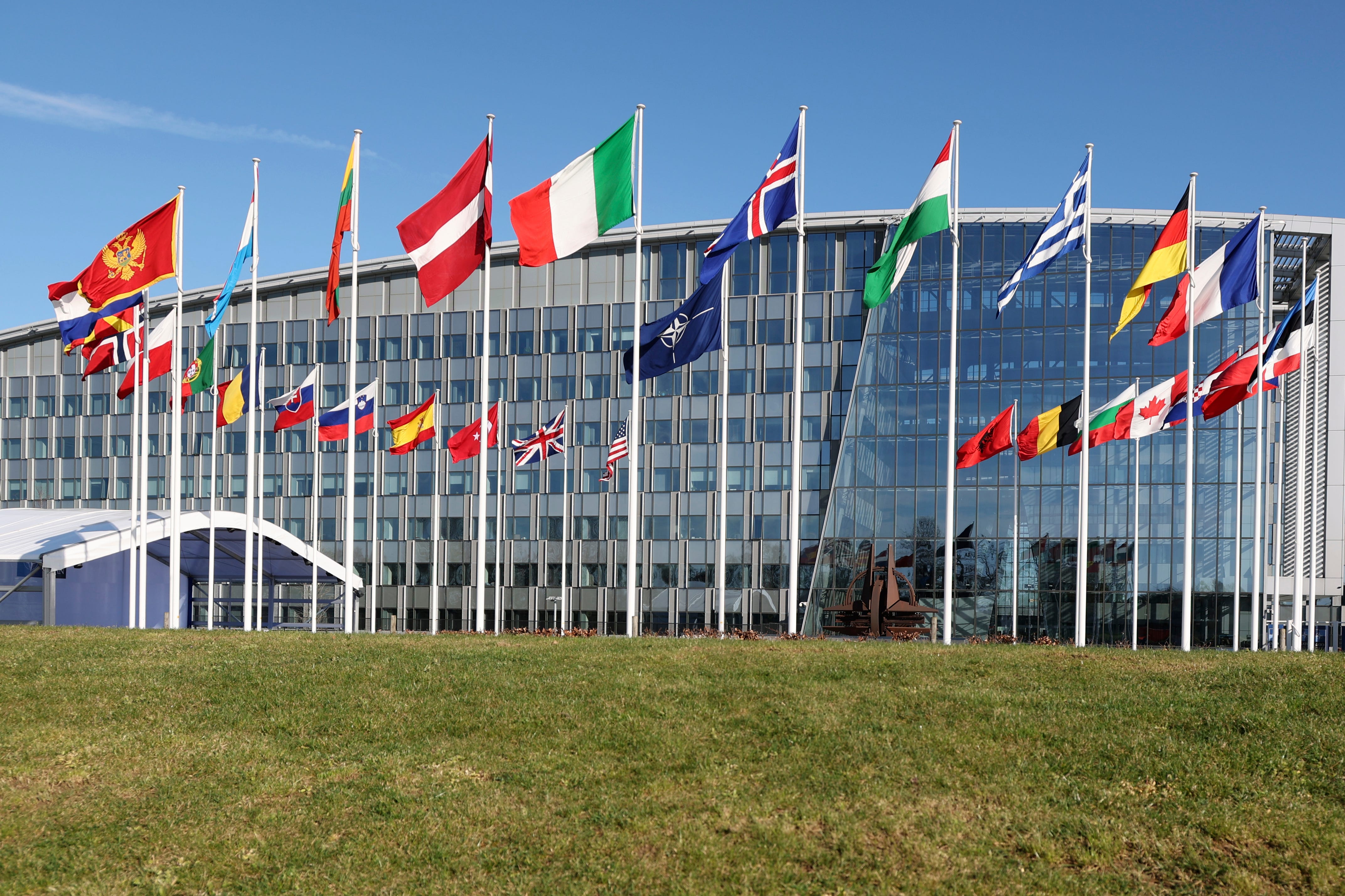 Flags of member nations flap in the wind outside NATO headquarters during a meeting of NATO foreign ministers in Brussels, Tuesday, April 4, 2023.AP Photo/Geert Vanden Wijngaert