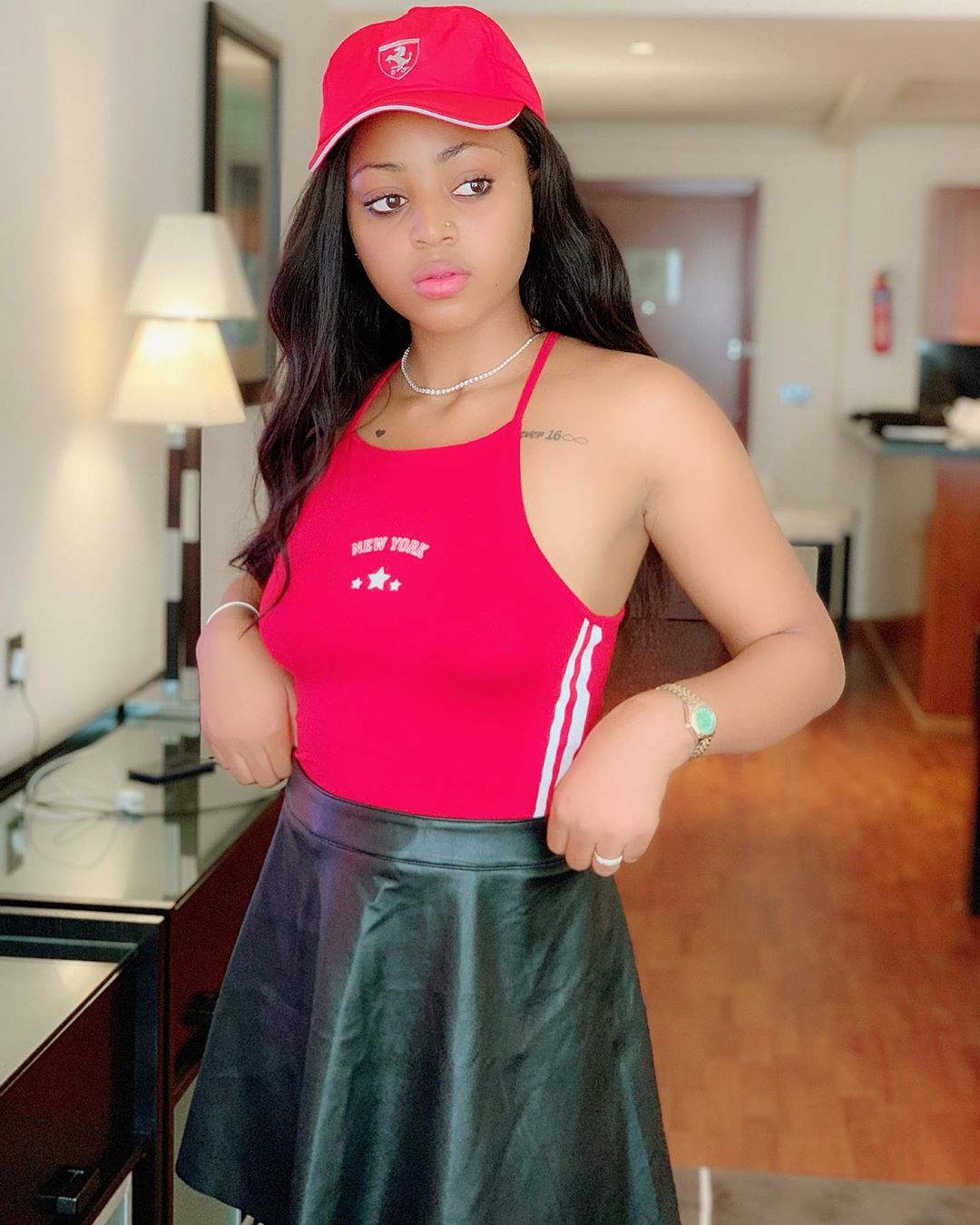 Just a little above Regina Daniels' cleavage is the phrase, Forever 16 with an infinity sign. [Instagram/regina,daniels]