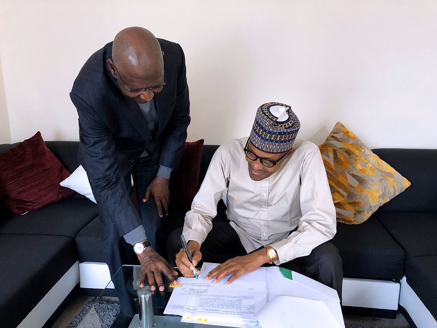 President Muhammadu Buhari signs Deep Offshore bill into law in London, with Chief of Staff Abba Kyari (Twitter: @BashirAhmaad) 