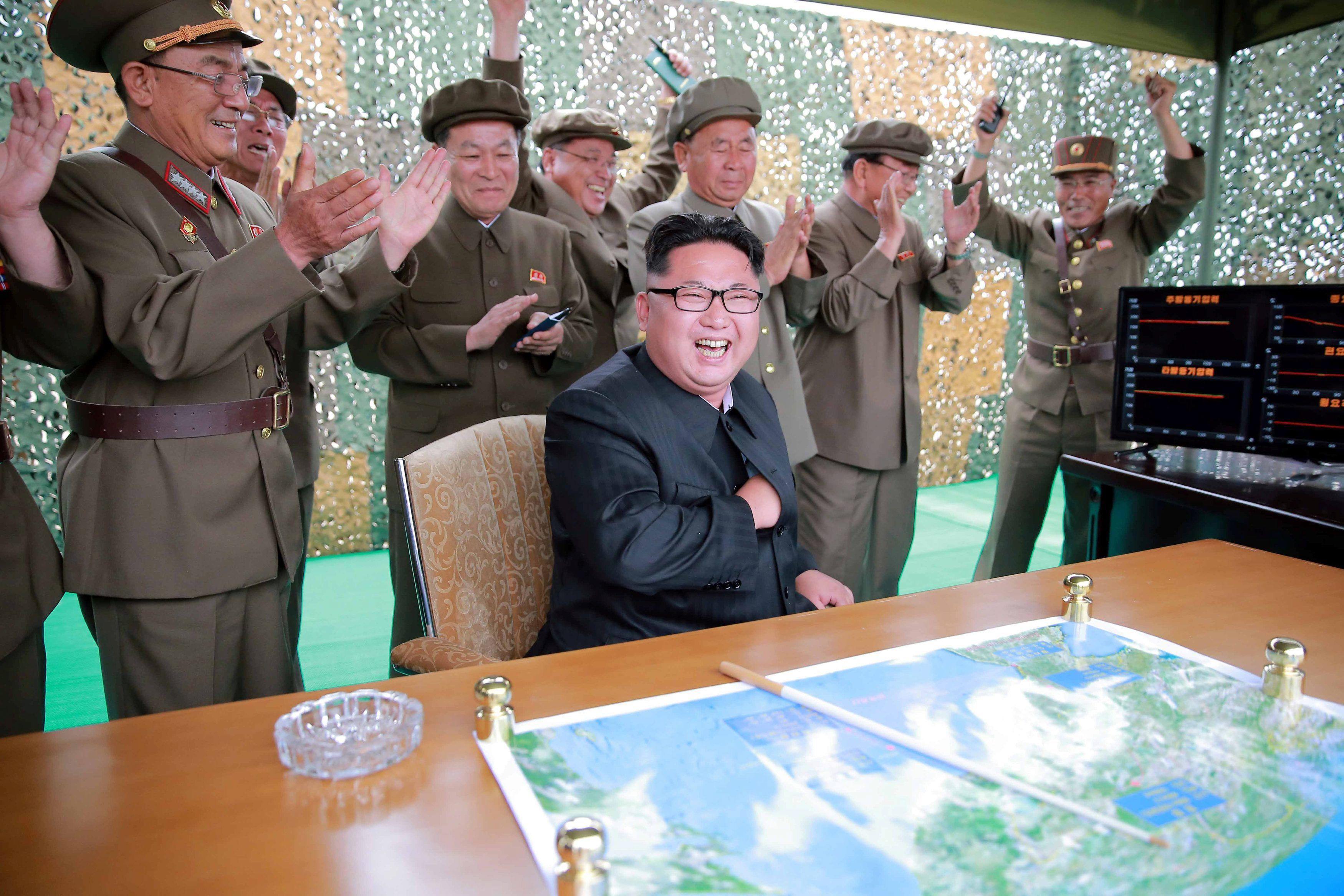 North Korean leader Kim Jong Un reacts during a test launch of ground-to-ground medium long-range ba