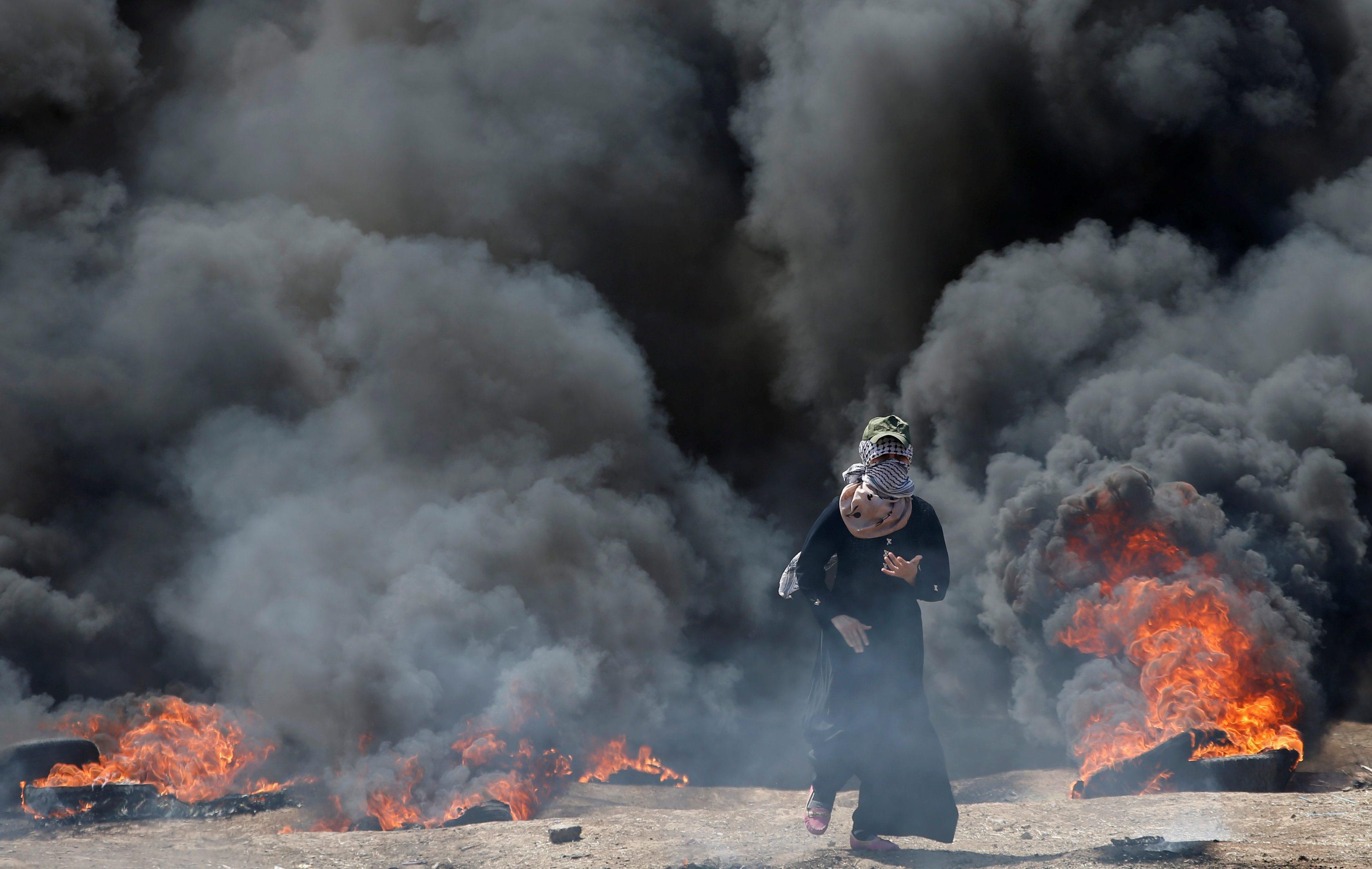 Female Palestinian demonstrator gestures during a protest against U.S. embassy move to Jerusalem and