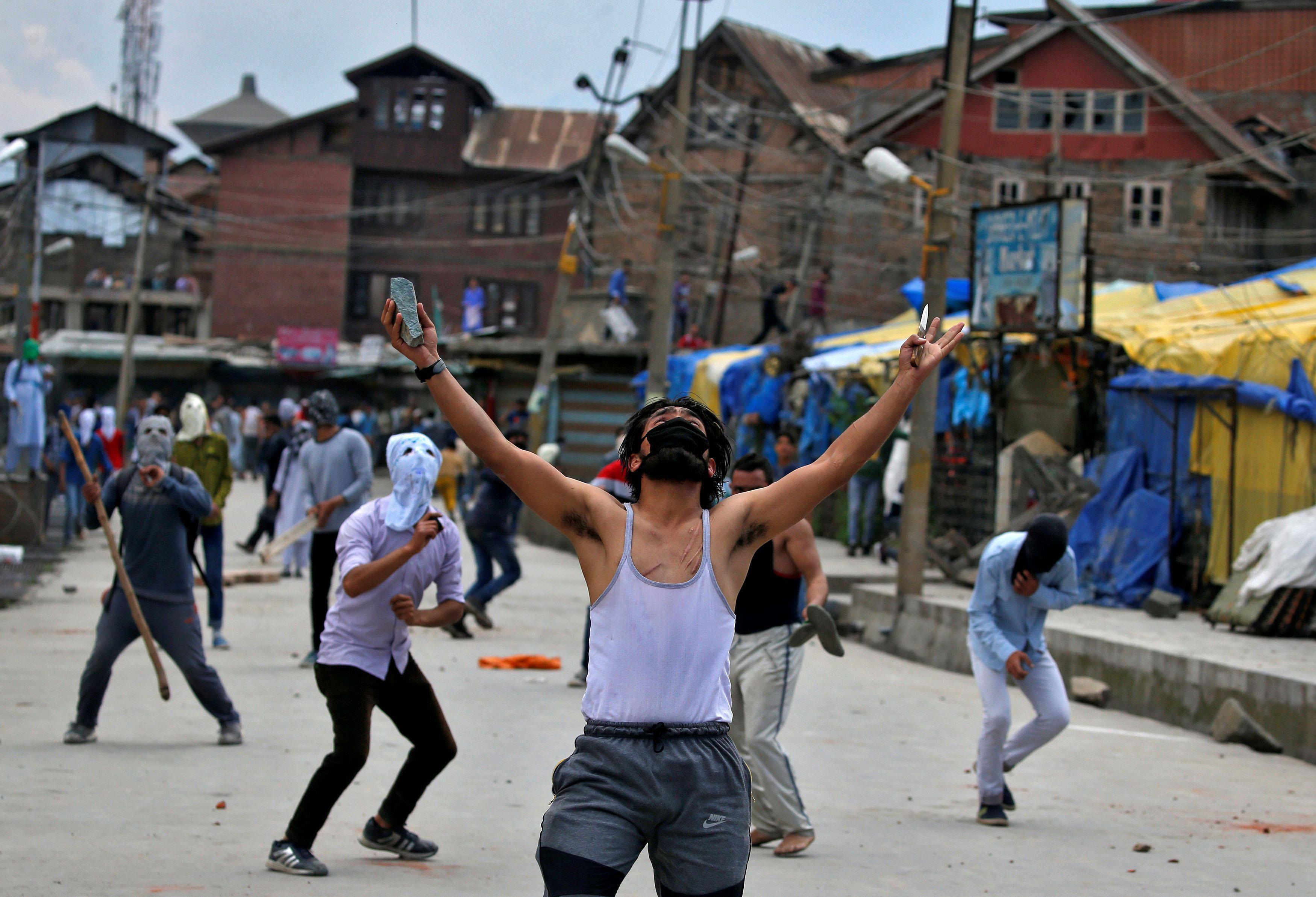 The Wider Image: Kashmir's stone-pelters face off against pellet guns