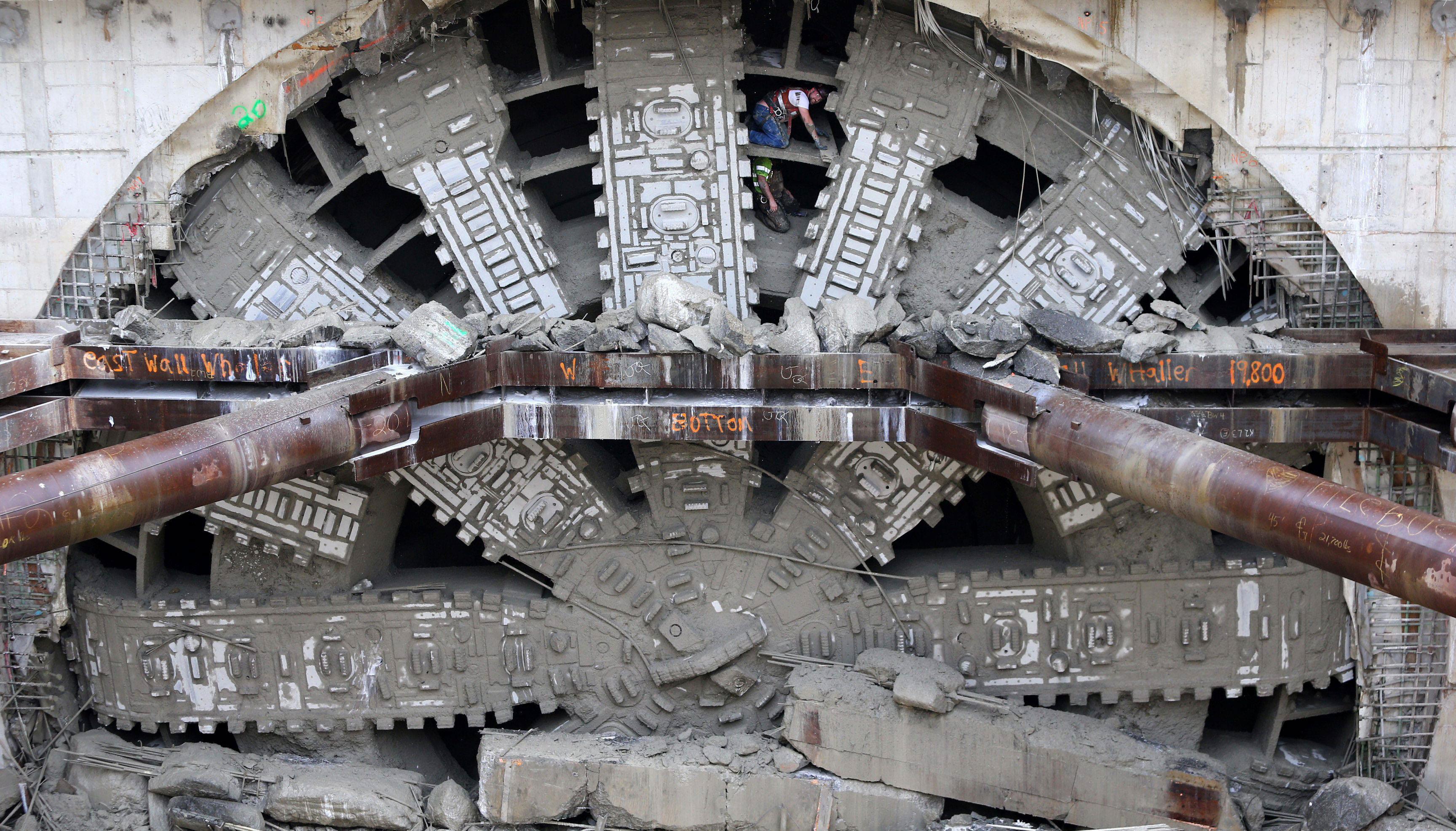 Workers celebrate by posing inside the giant teeth of Seattle?s tunnel-drilling machine, Bertha, the