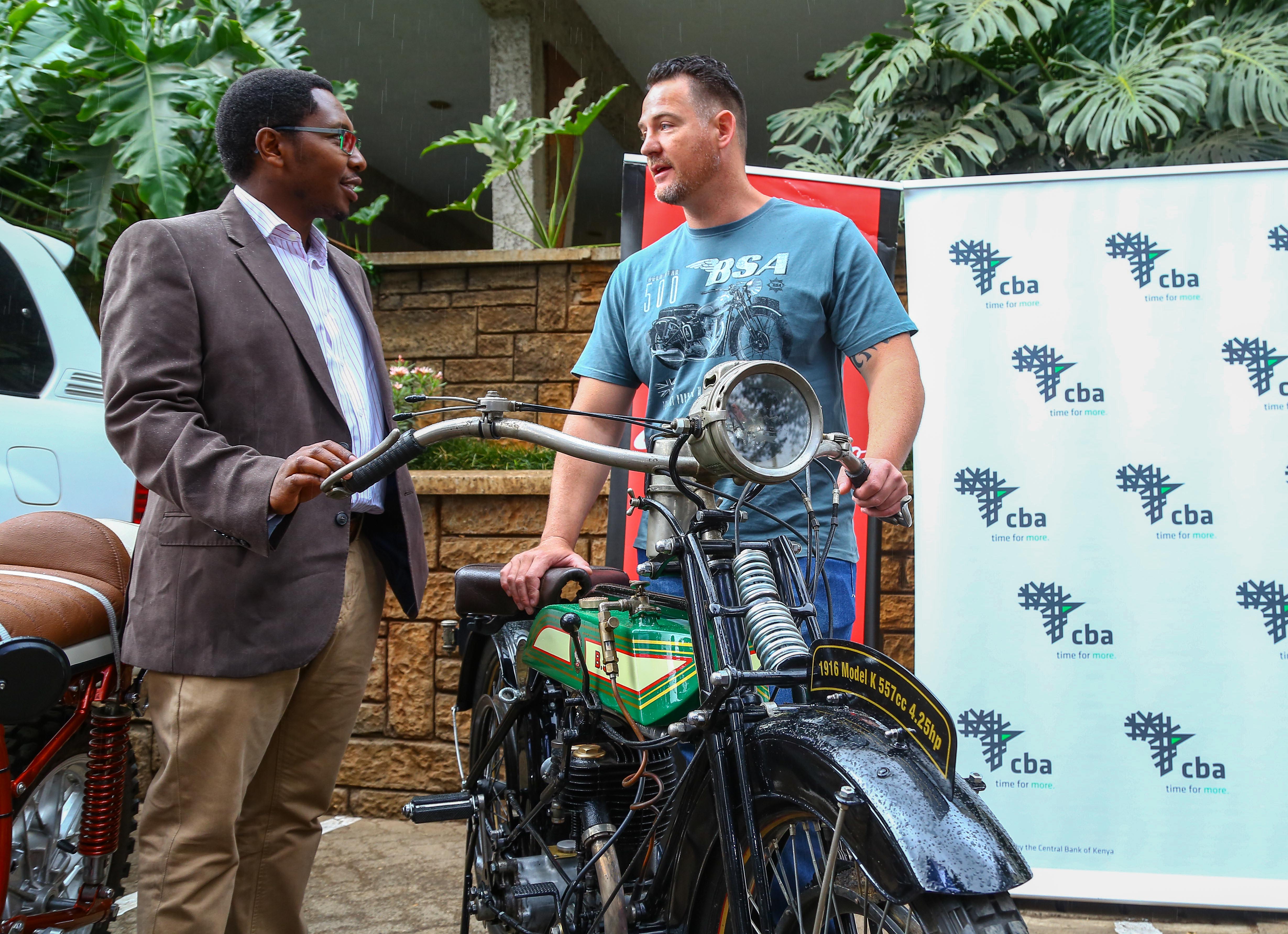 Chris Pasha(left)Group Head of Marketing CBA his taken through the contours of andhistory of a 1916 BSA model motorcycle by the owner Bevan Beckmann, a head ofthe 2019 Concours D’elegance.