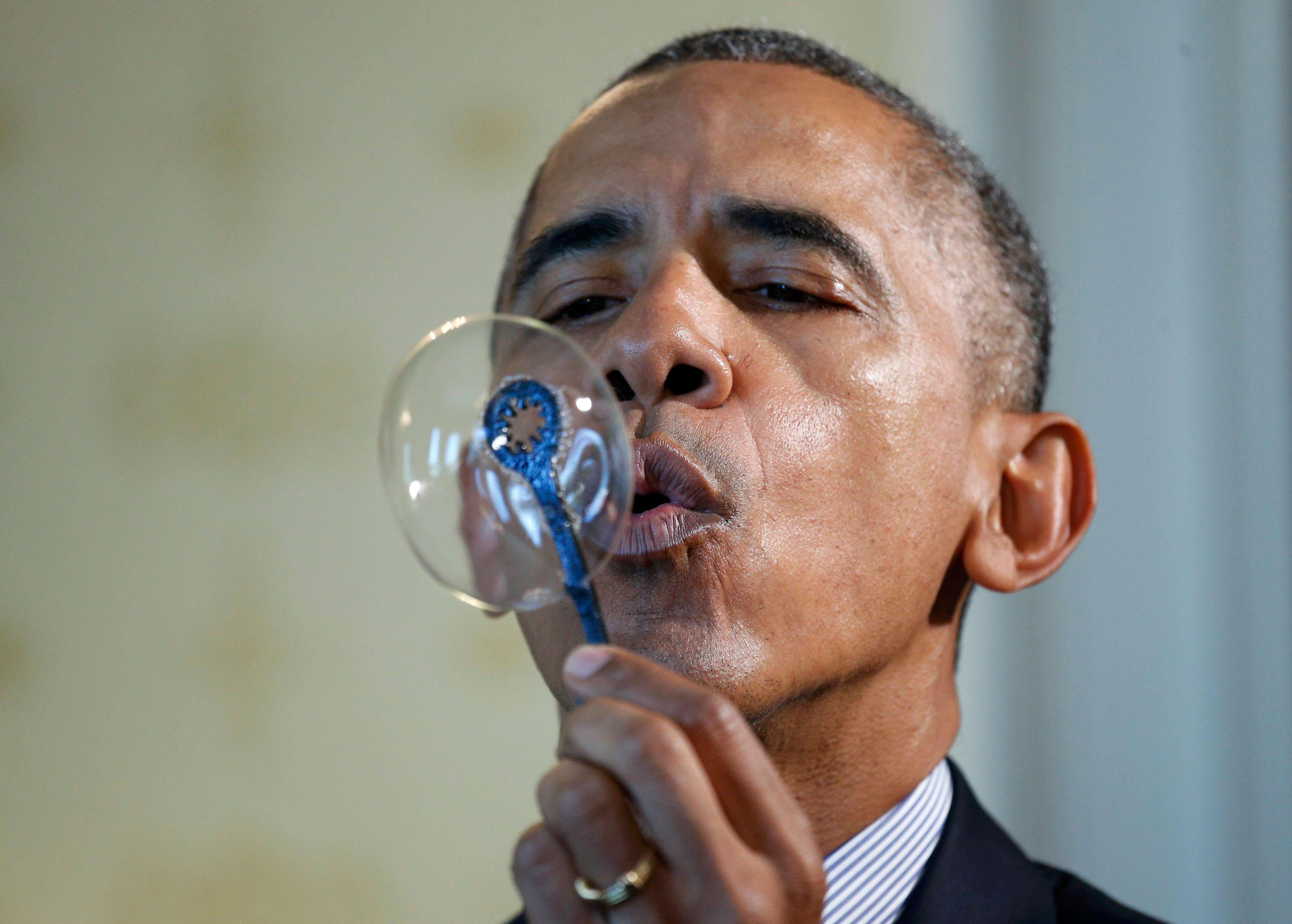 U.S. President Obama blows bubbles during the 2016 White House Science Fair in Washhington