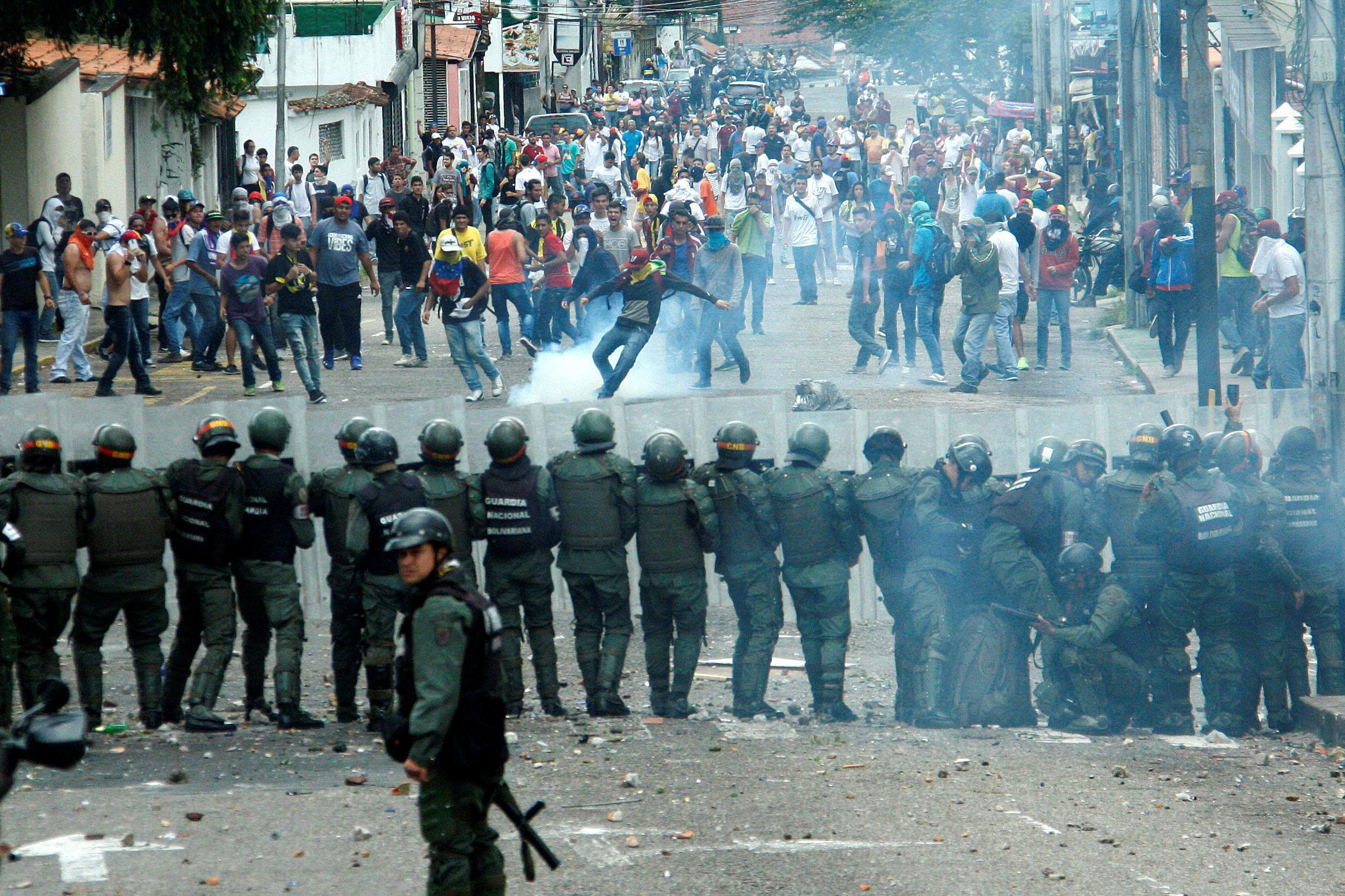 Demonstrators clash with members of Venezuelan National Guard during a rally demanding a referendum 