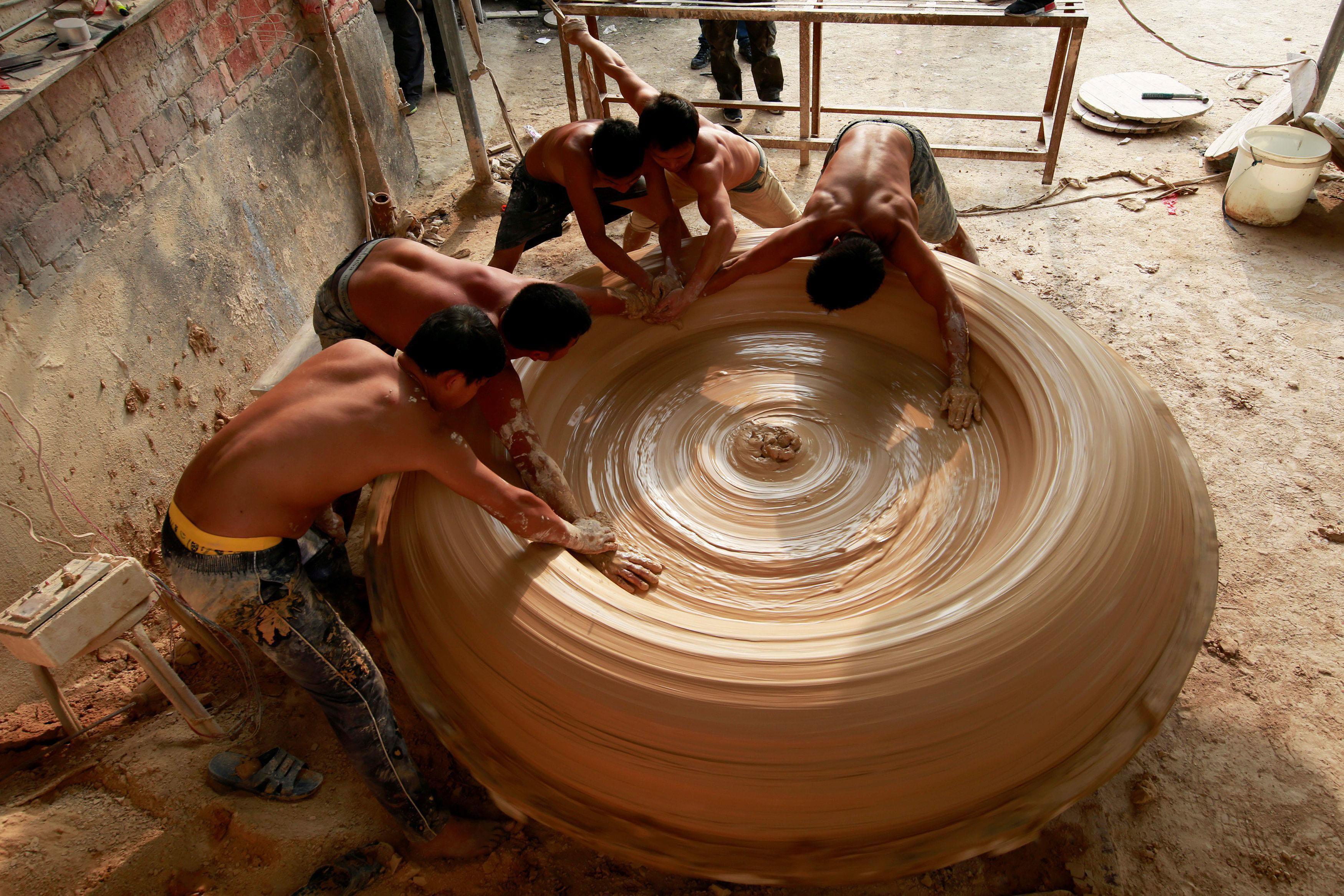 Workers make vat at porcelain factory in Jingdezhen