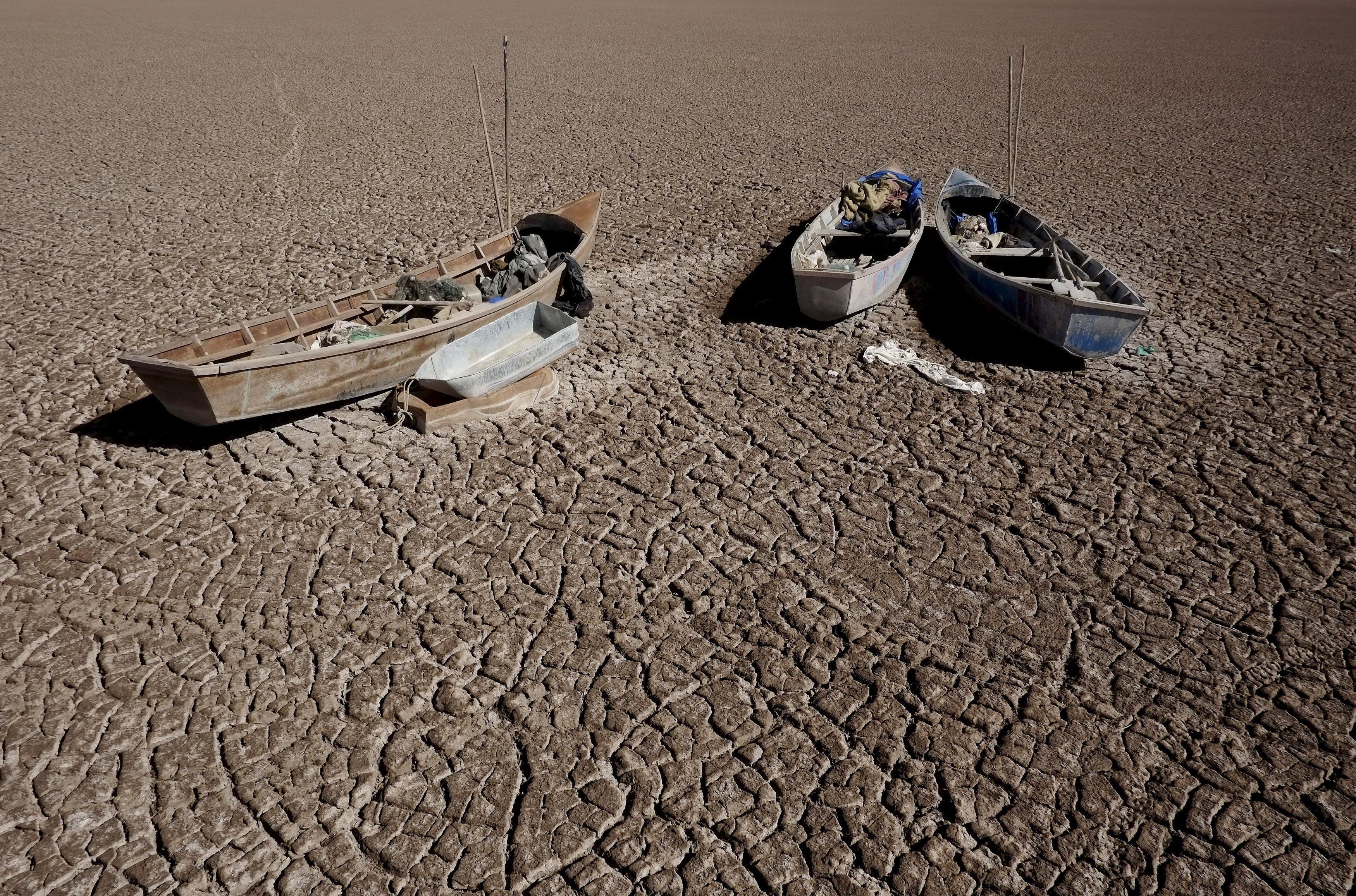 Boats of fishermen are seen on the dried Poopo lakebed in the Oruro Department, south of La Paz