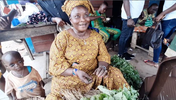 A food vendor in Igbo Ora, displaying the Okra leaf