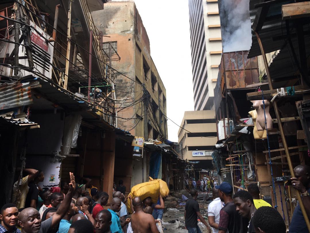 Onlookers at the Balogun market fire incident scene. [Pulse]