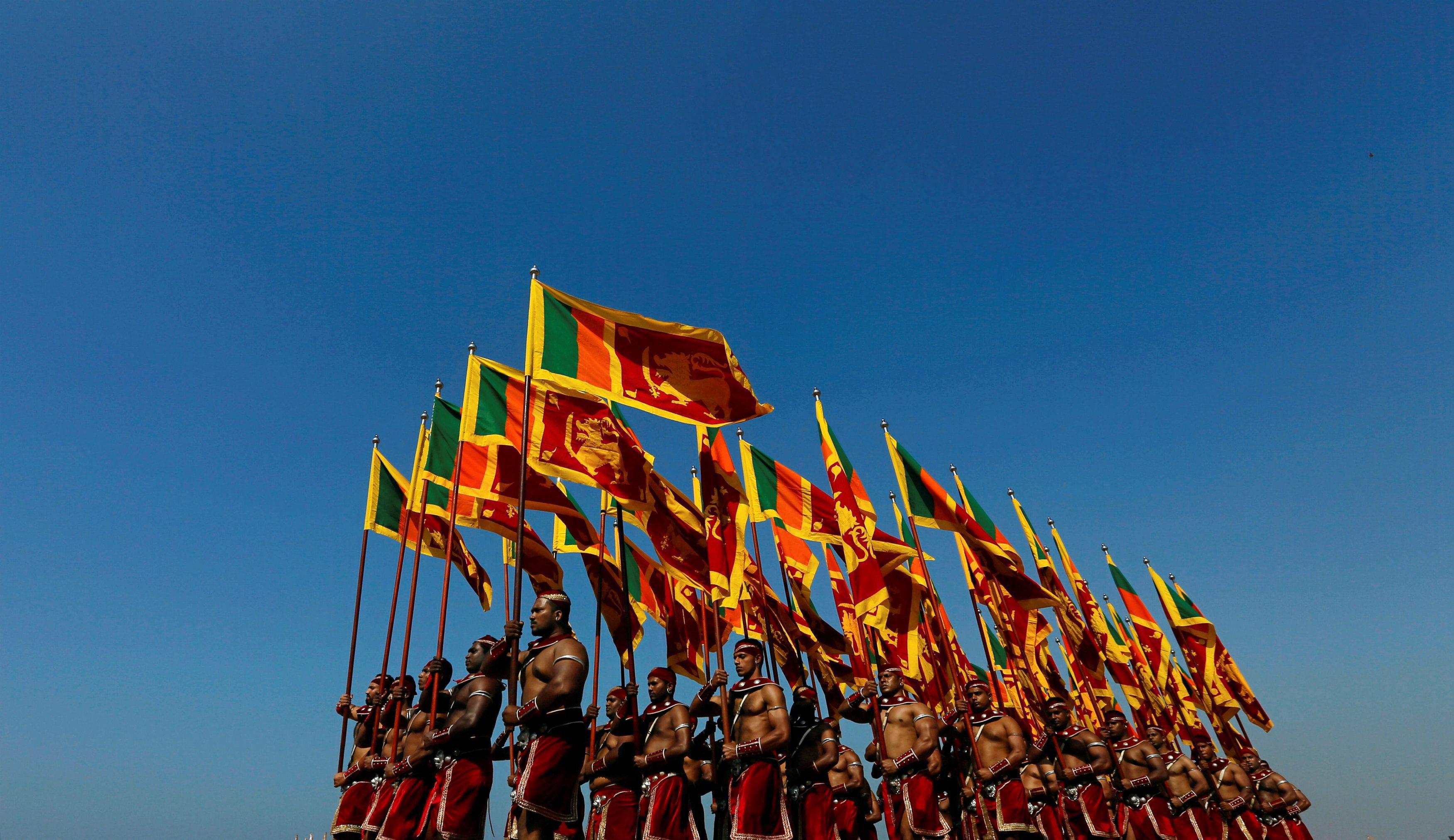 Sri Lanka's military members march with the national flags at the parade during a rehearsal for Sri 