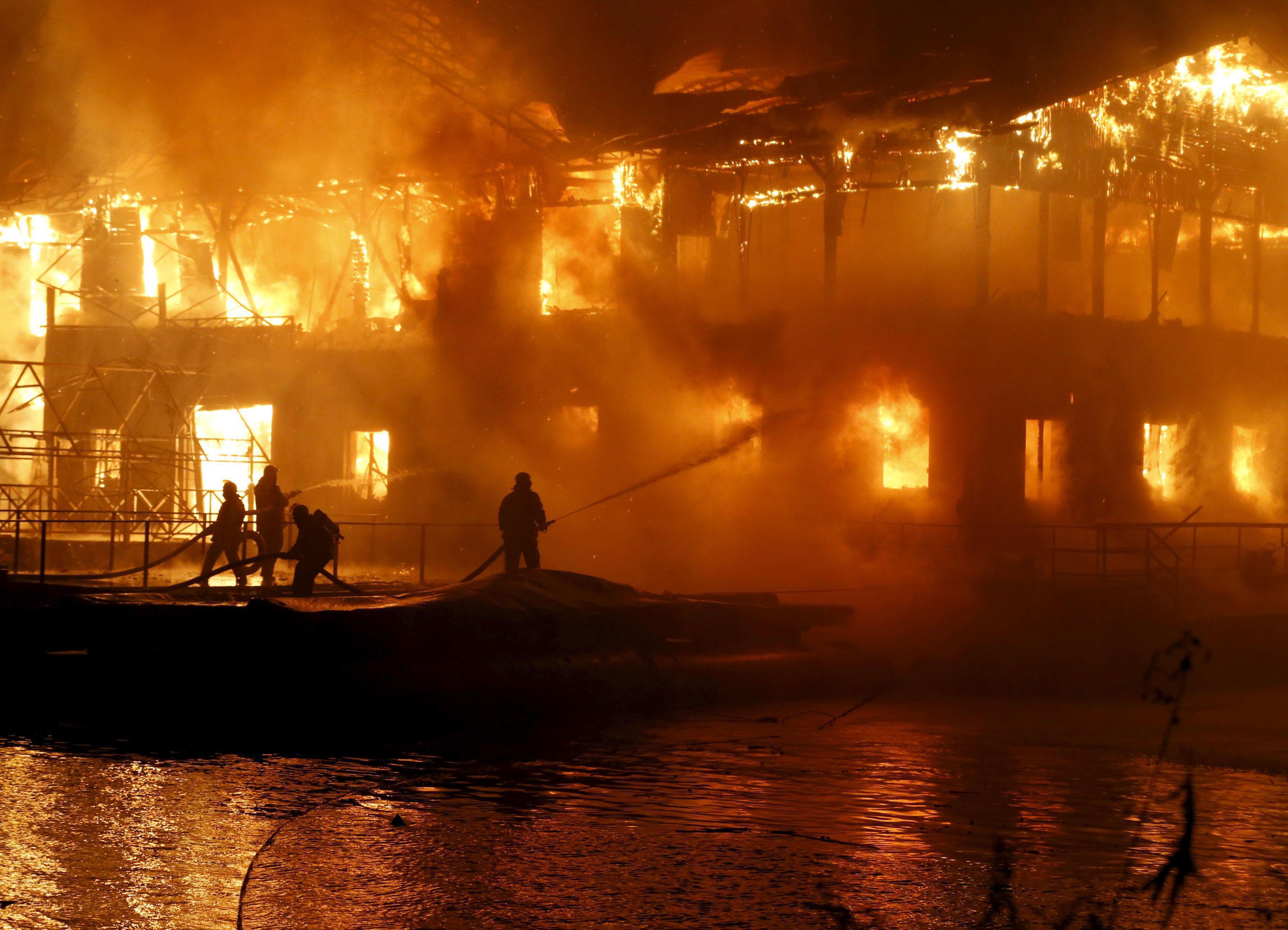 Firefighters work to extinguish fire at floating restaurant in Kiev