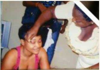 Bukky Iyabo Oshadare making up Mercy Aigbe on the set of a Yoruba movie. [Nigeriafilms]