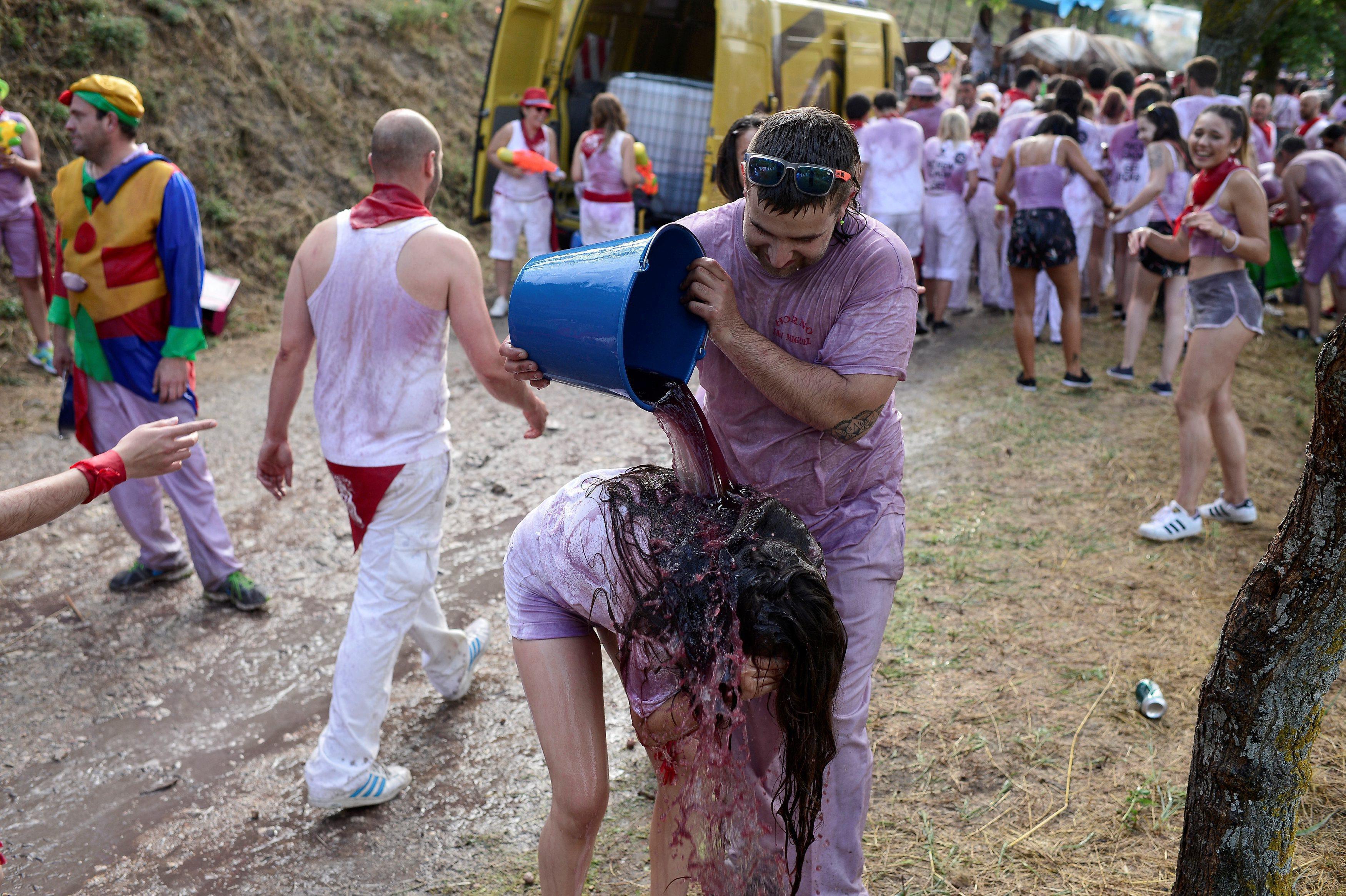 A reveller has wine poured over her during the Batalla de Vino (Wine Battle) in Haro