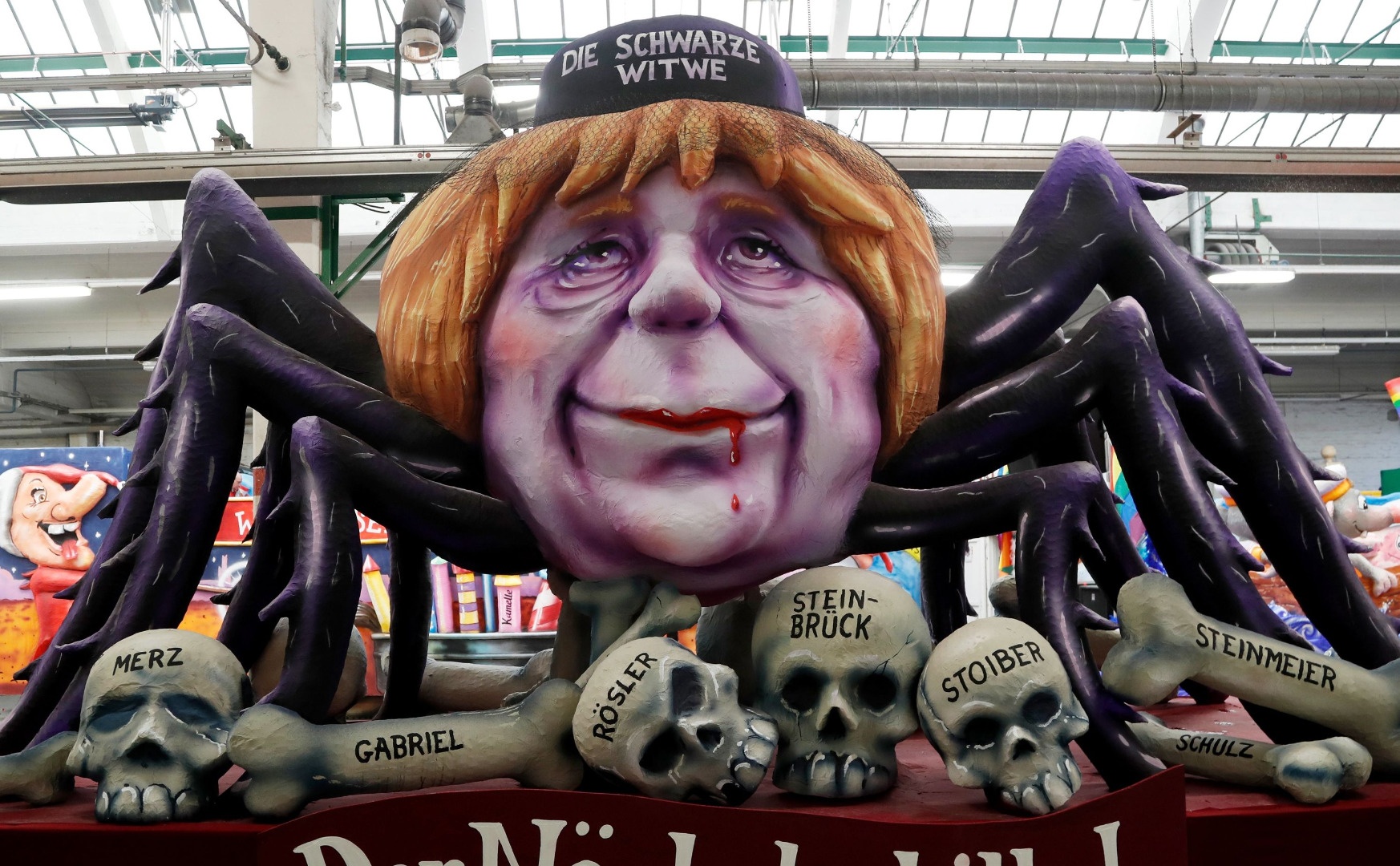 Angela Merkel jako pająk, który pożarł swoją konkurencję.