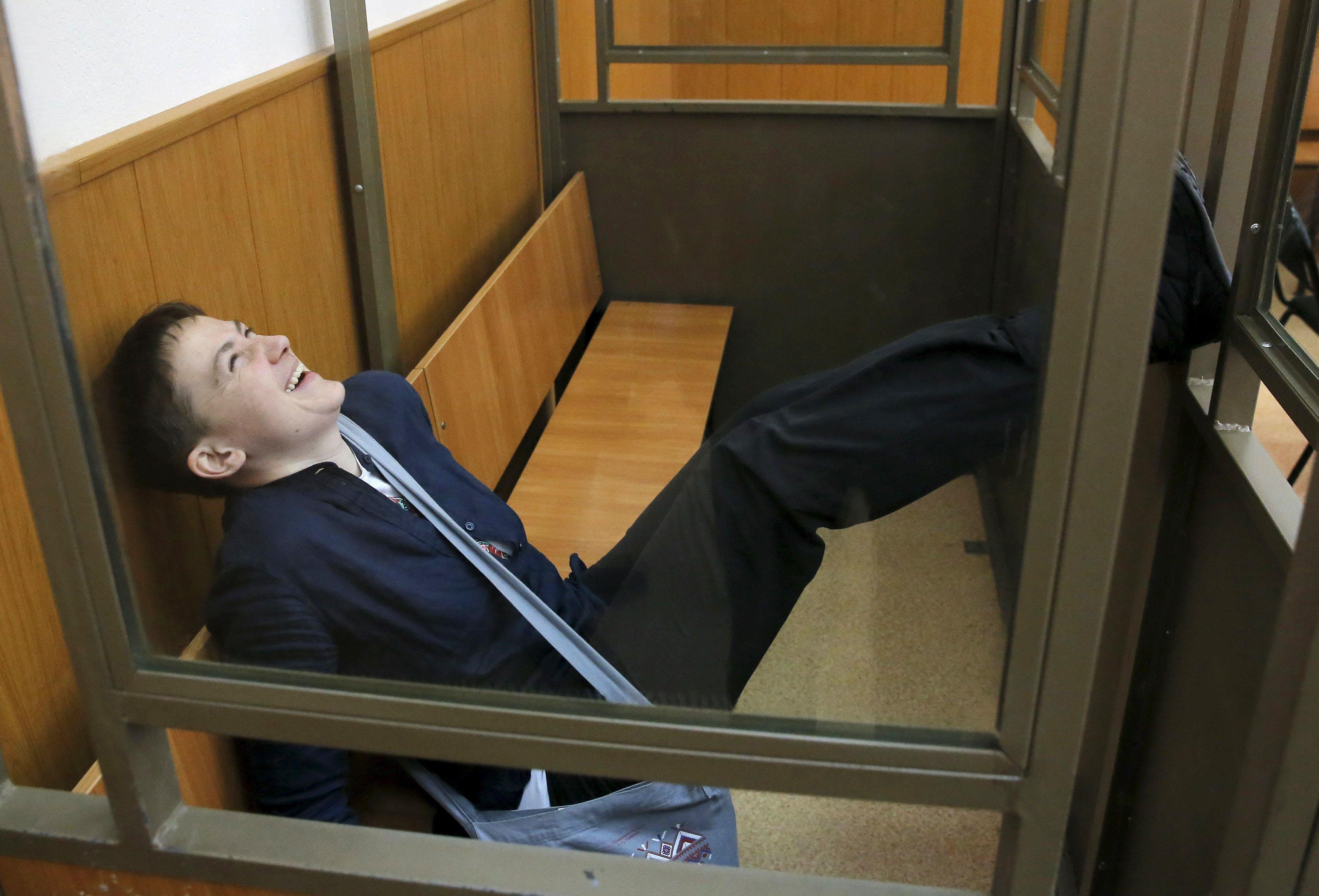 Former Ukrainian army pilot Savchenko reacts from glass-walled cage during verdict hearing at court 