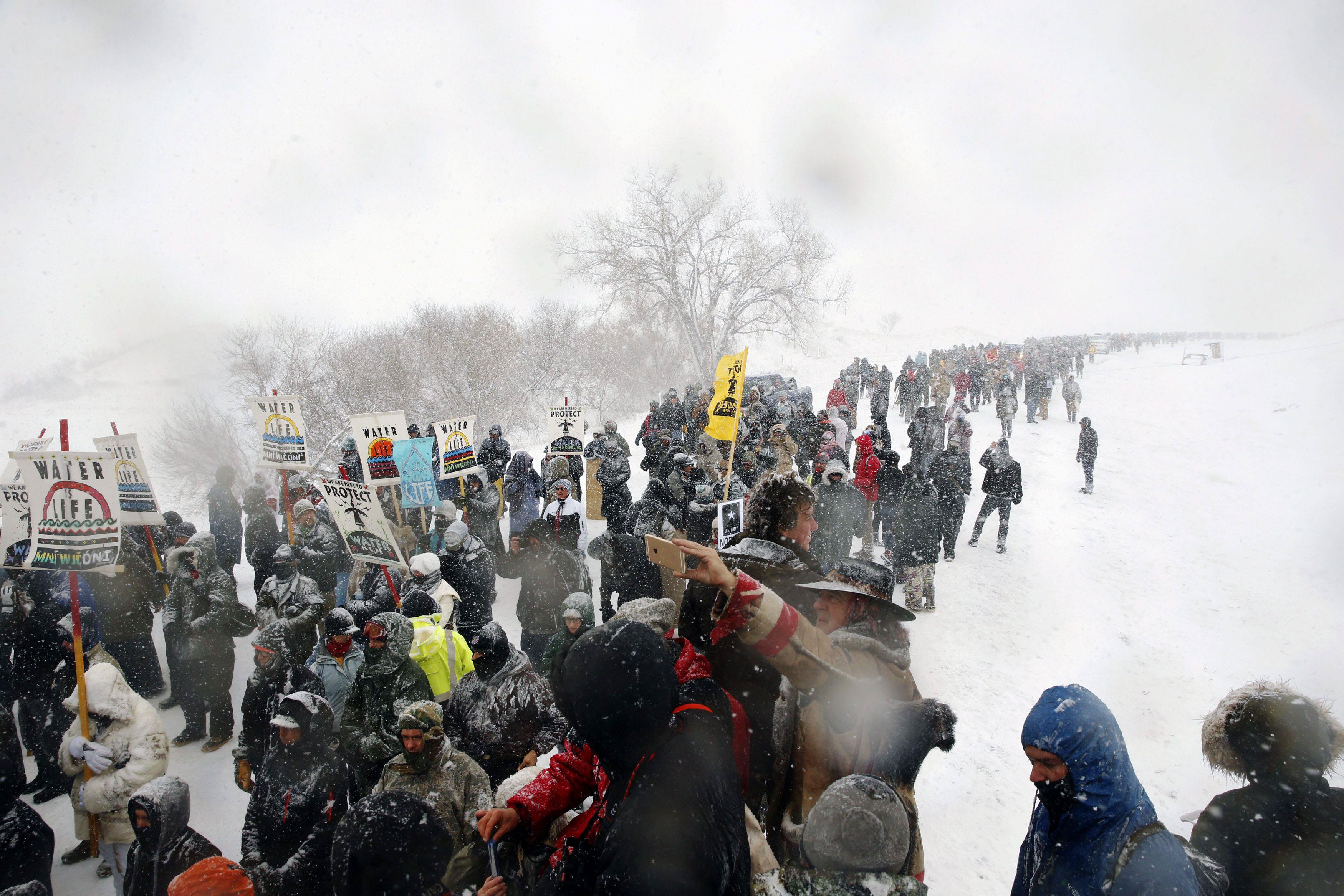 Veterans march with activists near Backwater Bridge just outside of the Oceti Sakowin camp during a 
