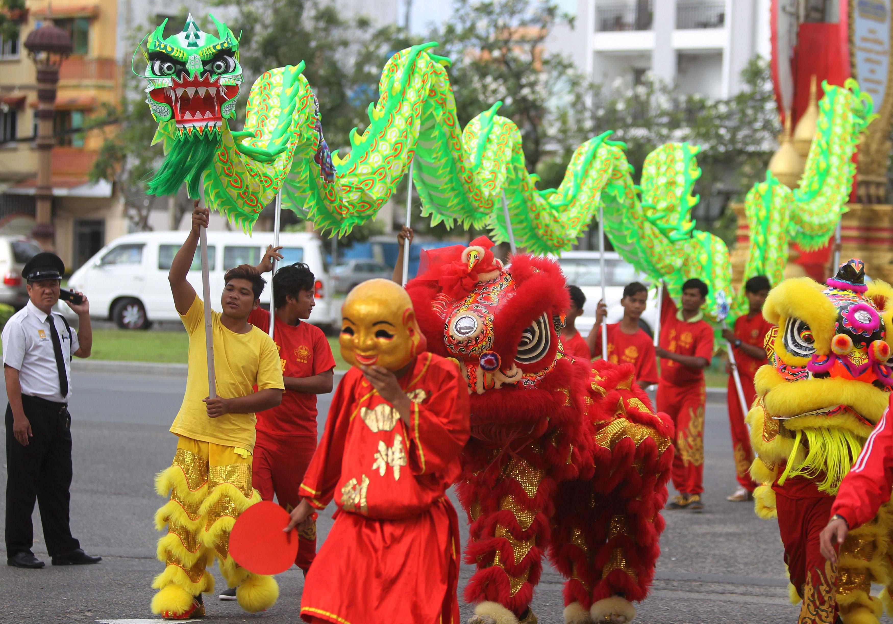 Men perform a dragon and lion dance ahead of the Chinese Lunar New Year in Phnom Penh