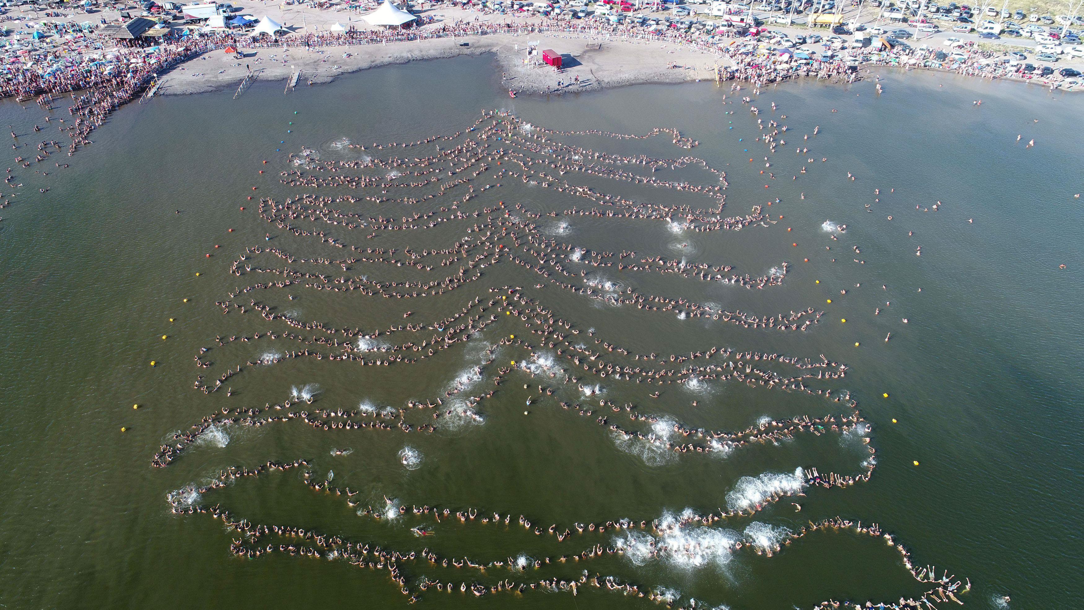 Nearly 2,000 people float in a line setting a new Guinness world record for the most people floating
