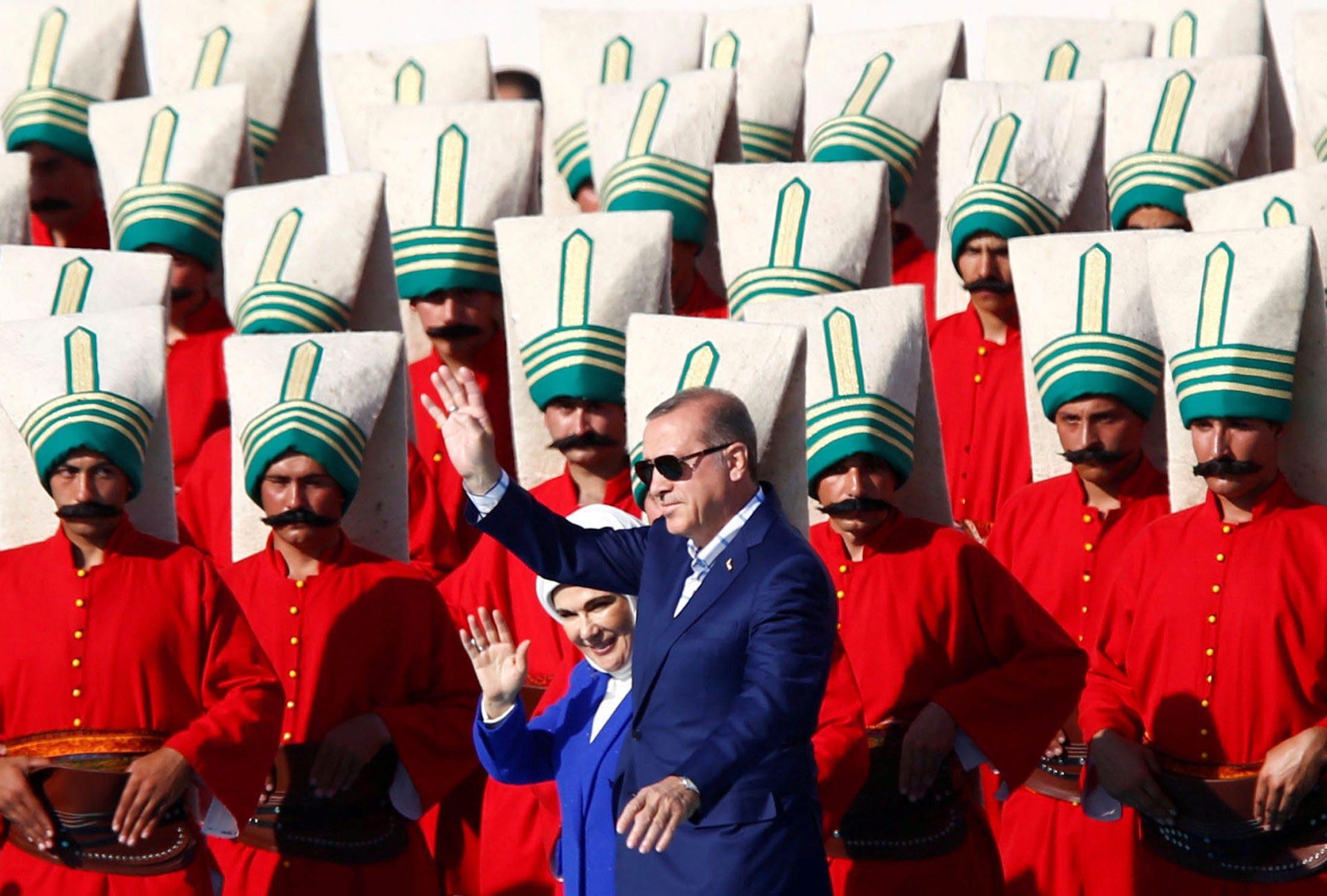 Turkish President Erdogan, accompanied by his wife Emine, greets supporters during a rally to mark t