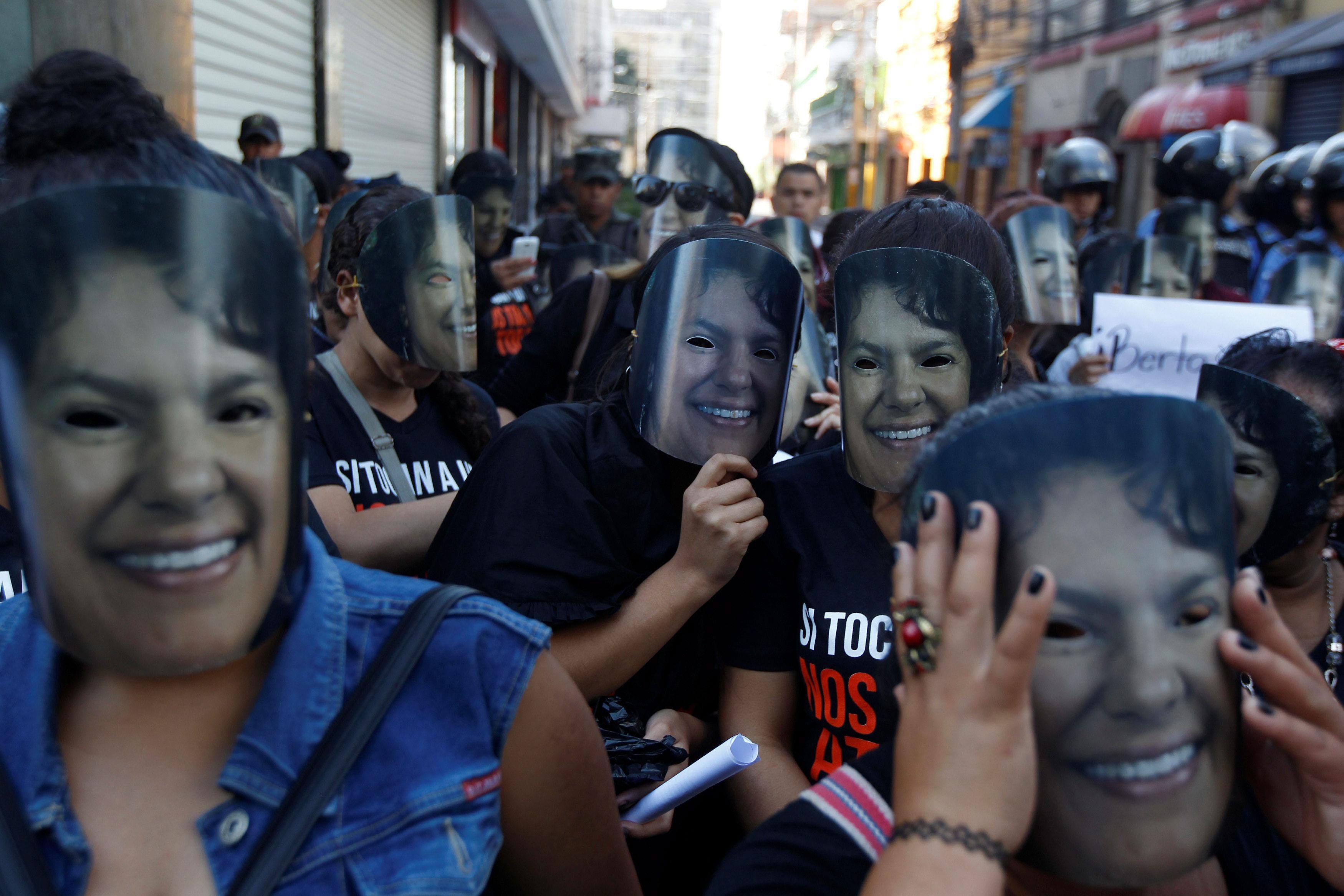 Demonstrators wear masks of slain environmental rights activist Berta Caceres during Honduran Women'