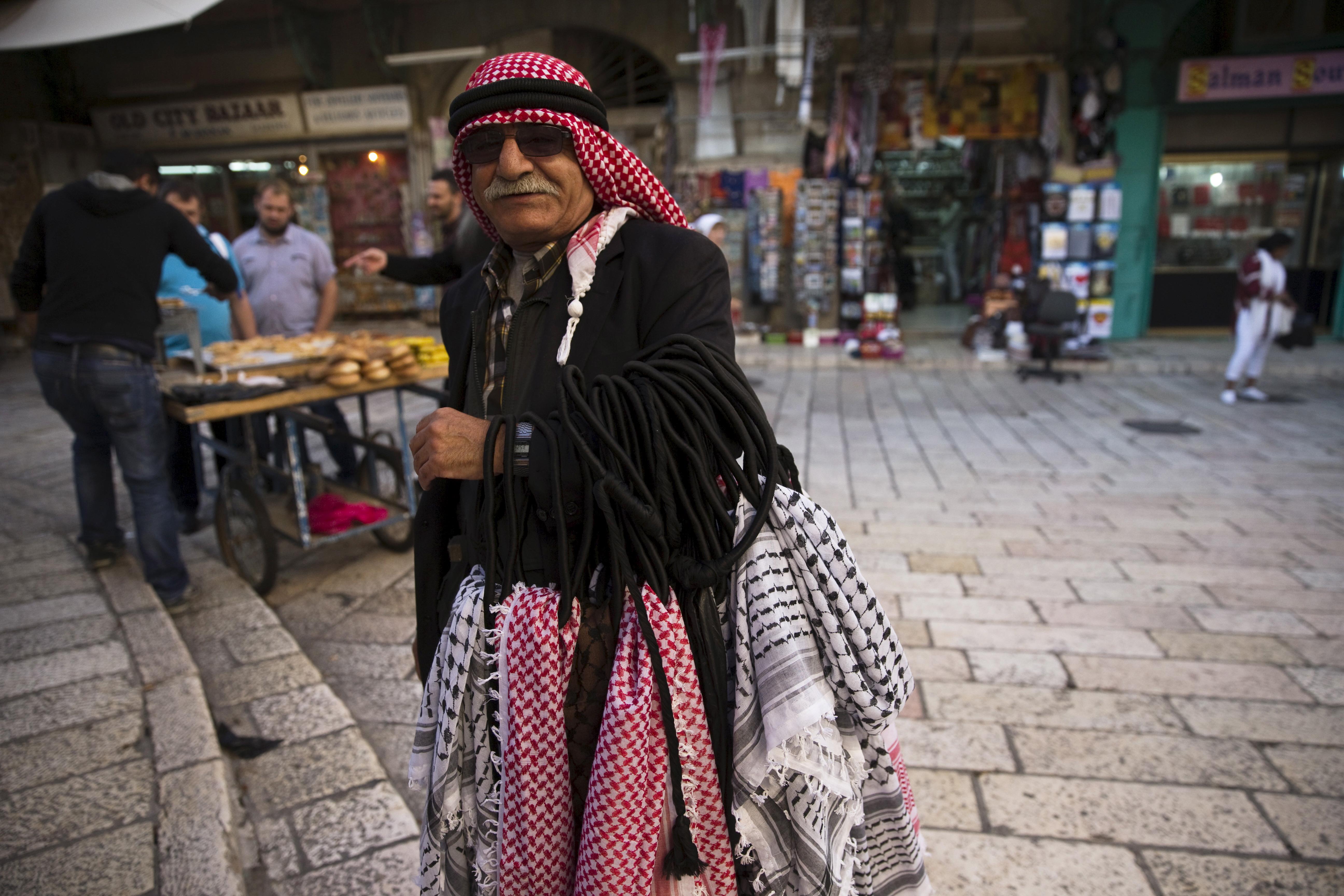 A Palestinian vendor stands near the Church of the Holy Sepulchre in Jerusalem's Old City 