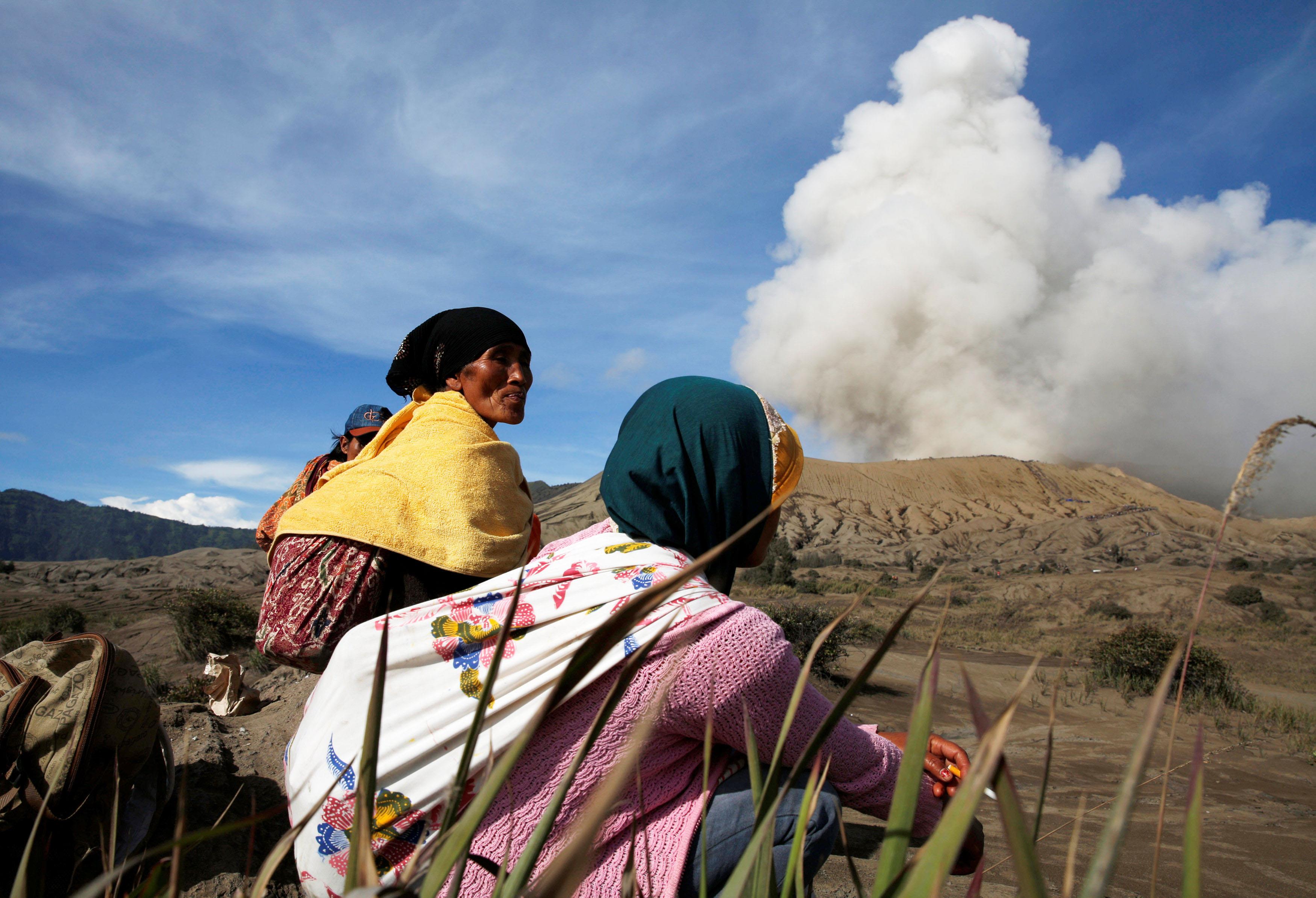 Mount Bromo spews ash as Hindu villagers rest ahead of Kasada ceremony in Probolinggo