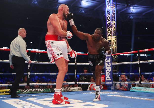 Dillian Whyte tries to catch an elusive Tyson Fury with a right hand 