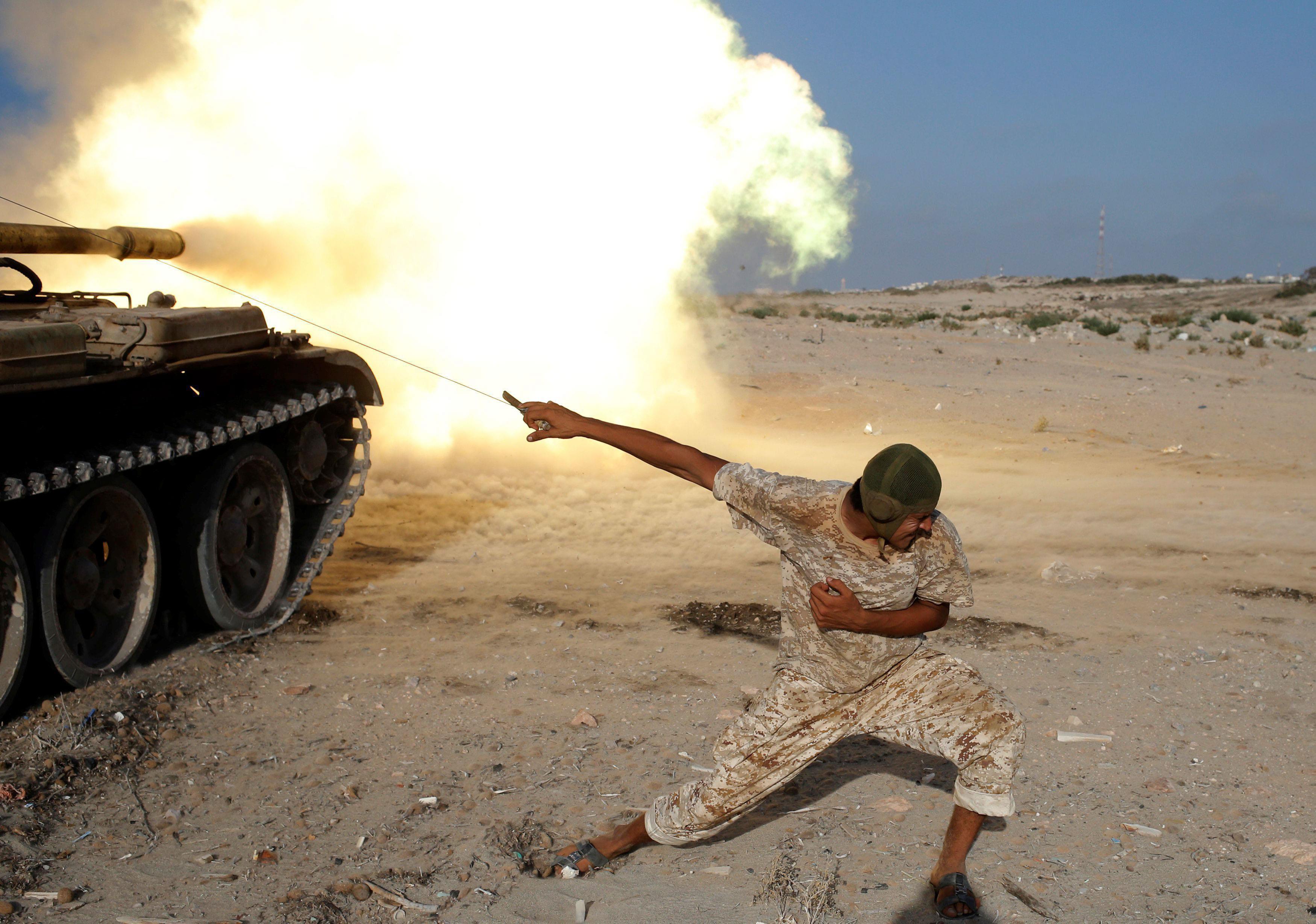 A fighter of Libyan forces allied with the U.N.-backed government fires a shell with Soviet made T-5