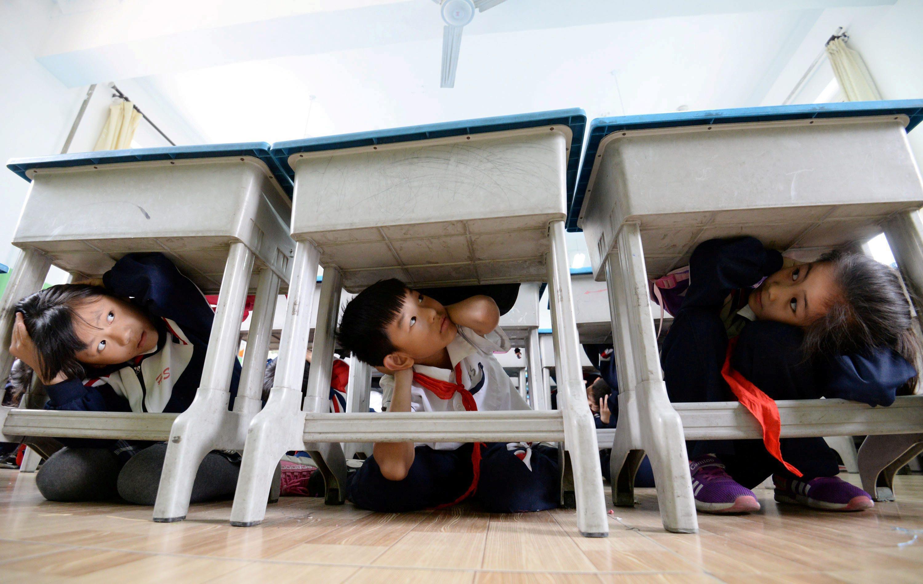 Primary school students take part in an earthquake drill ahead of the 10th anniversary of the 2008 S