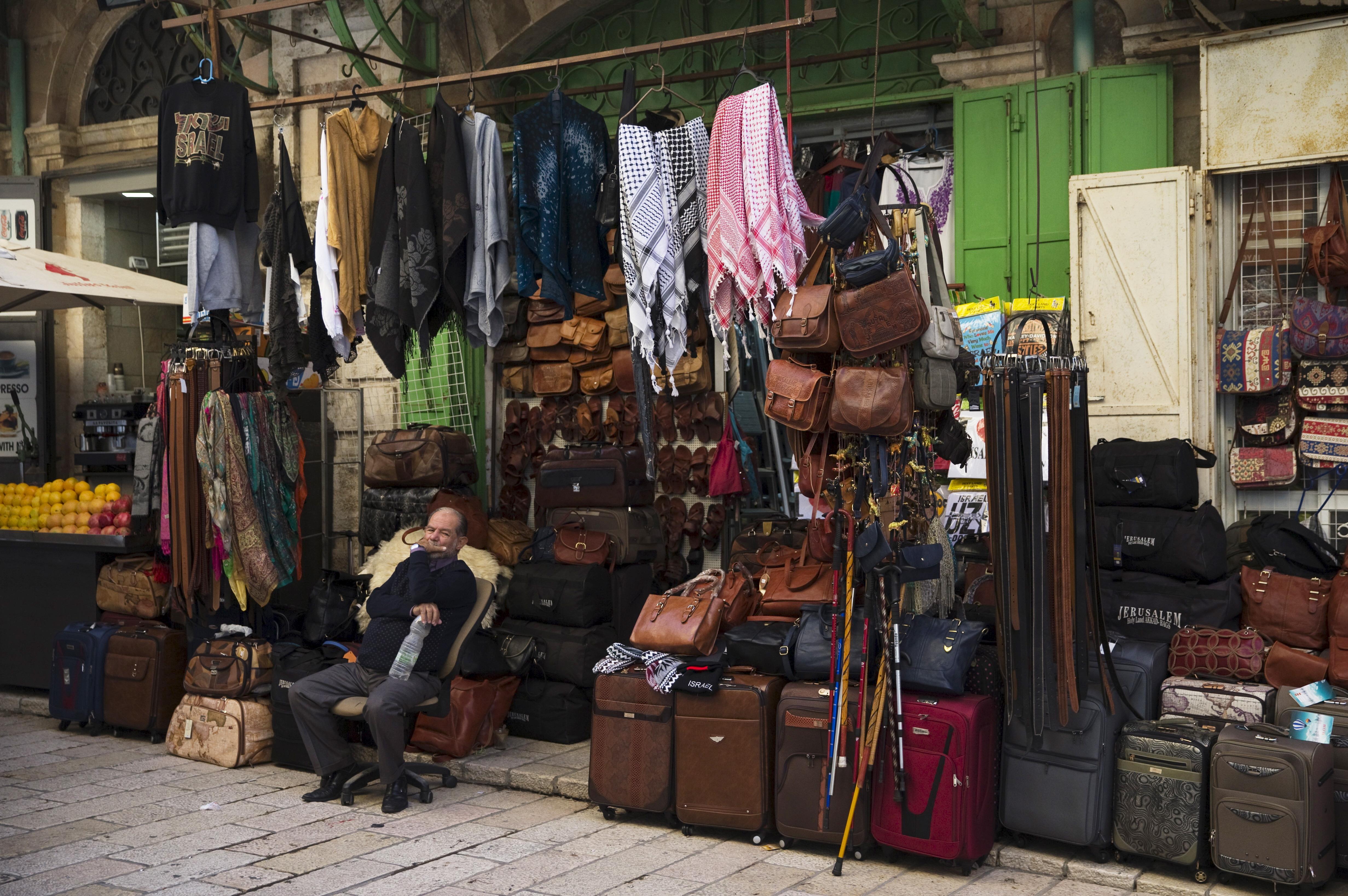 A Palestinian vendor sits outside his shop in Jerusalem's Old City 