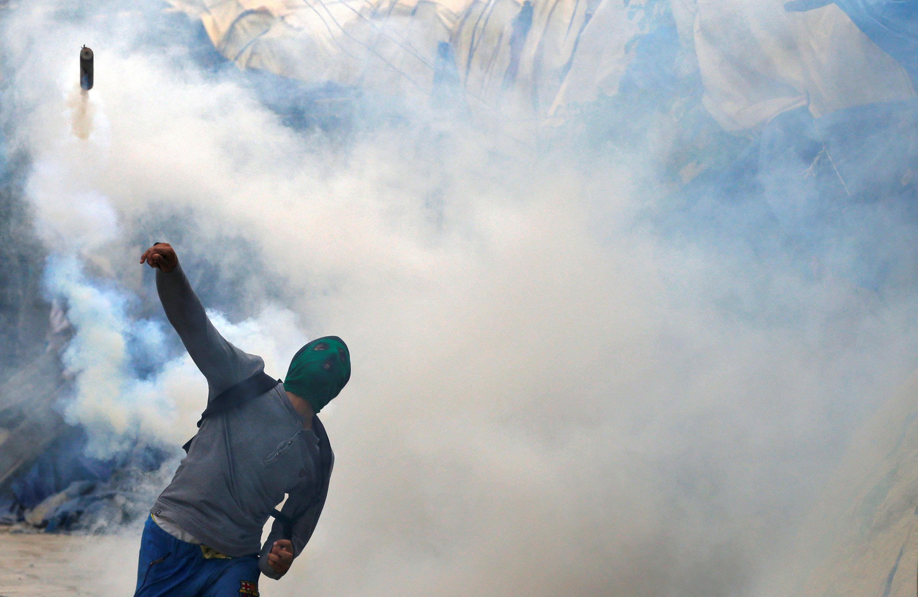 The Wider Image: Kashmir's stone-pelters face off against pellet guns