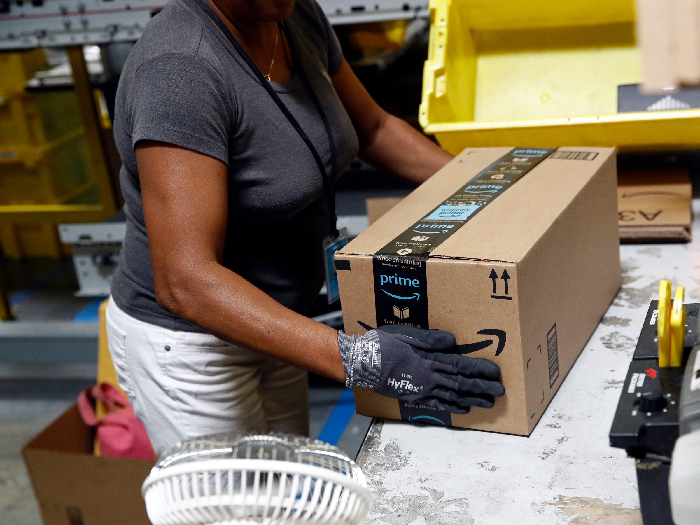 An Amazon worker holds a package at a fulfilment centre. Global players like Amazon are expanding in South Africa’s fast-growing e-commerce market. (AP Photo/Patrick Semansky, File)