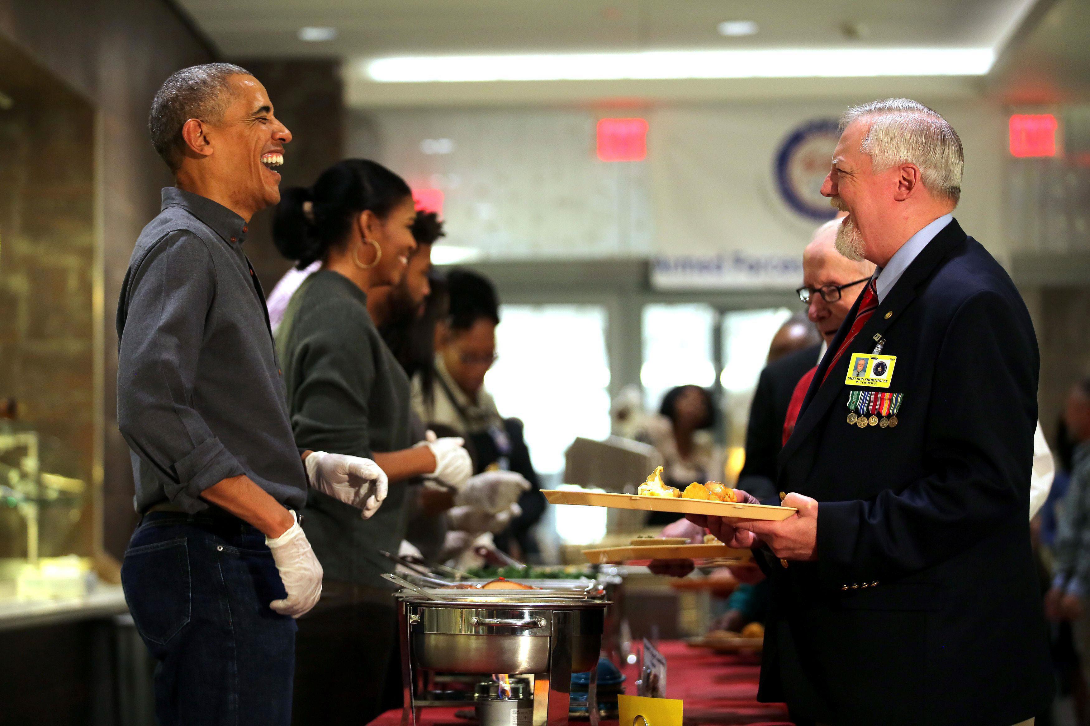 U.S. President Barack Obama and First Lady Michelle Obama serve Thanksgiving dinner to residents of 