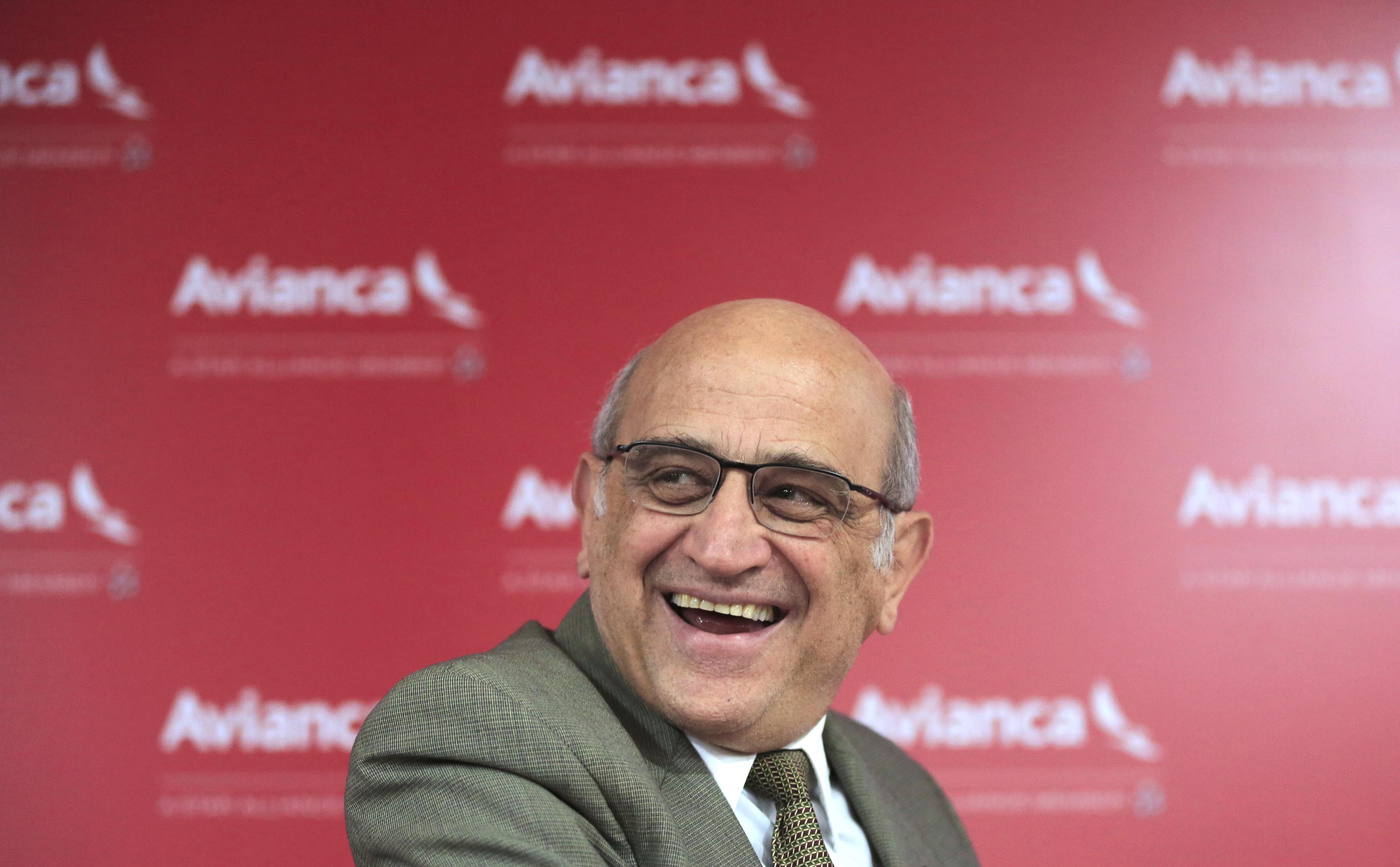Avianca airline owner Efromovich laughs as Villegas, president of Avianca company, speaks to reporte