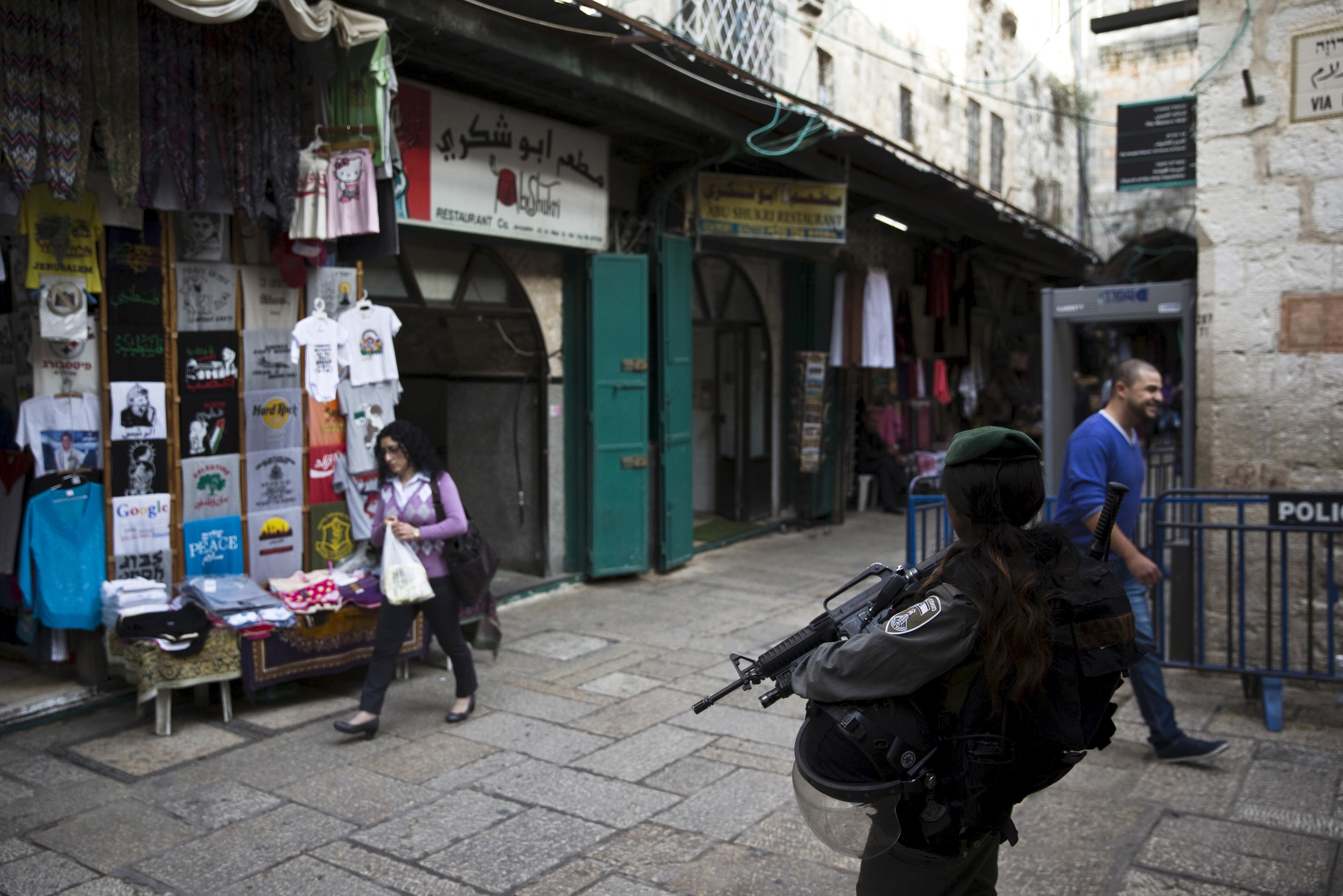 An Israeli border policewoman stands guard near Abu Shukri's hummus restaurant in Jerusalem's Old Ci