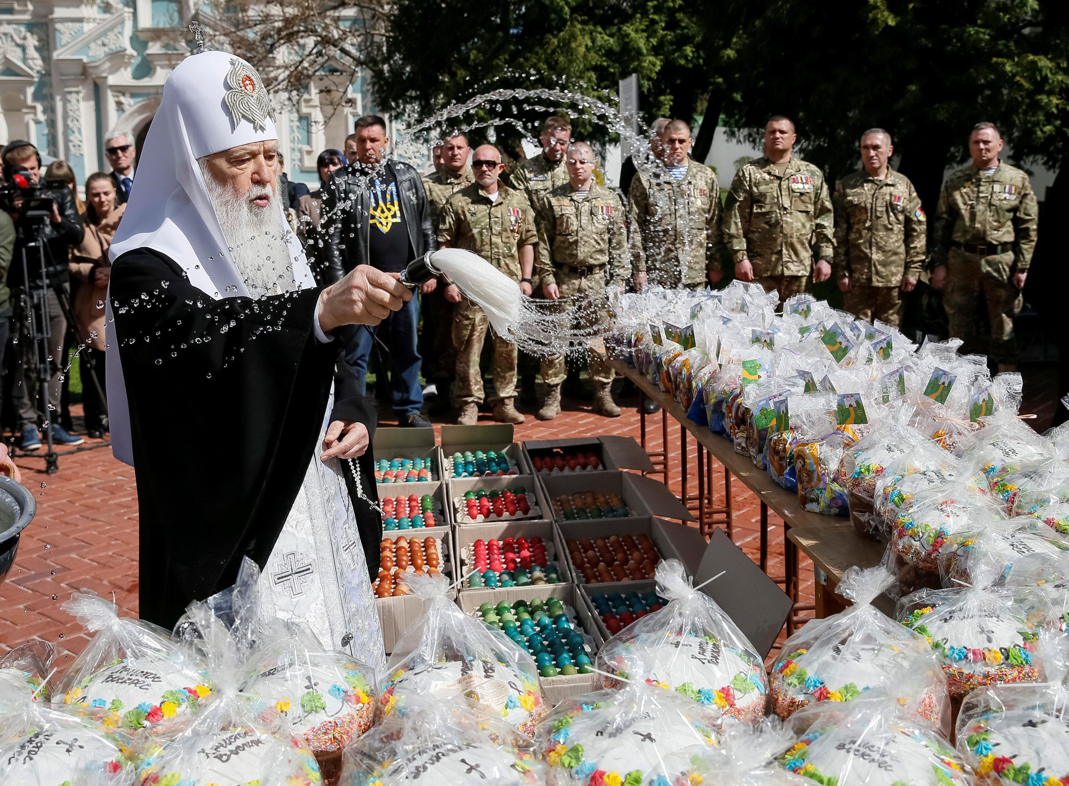 Metropolitan Filaret, the head of one of Ukraine's Orthodox churches, sprinkles holy water during a 