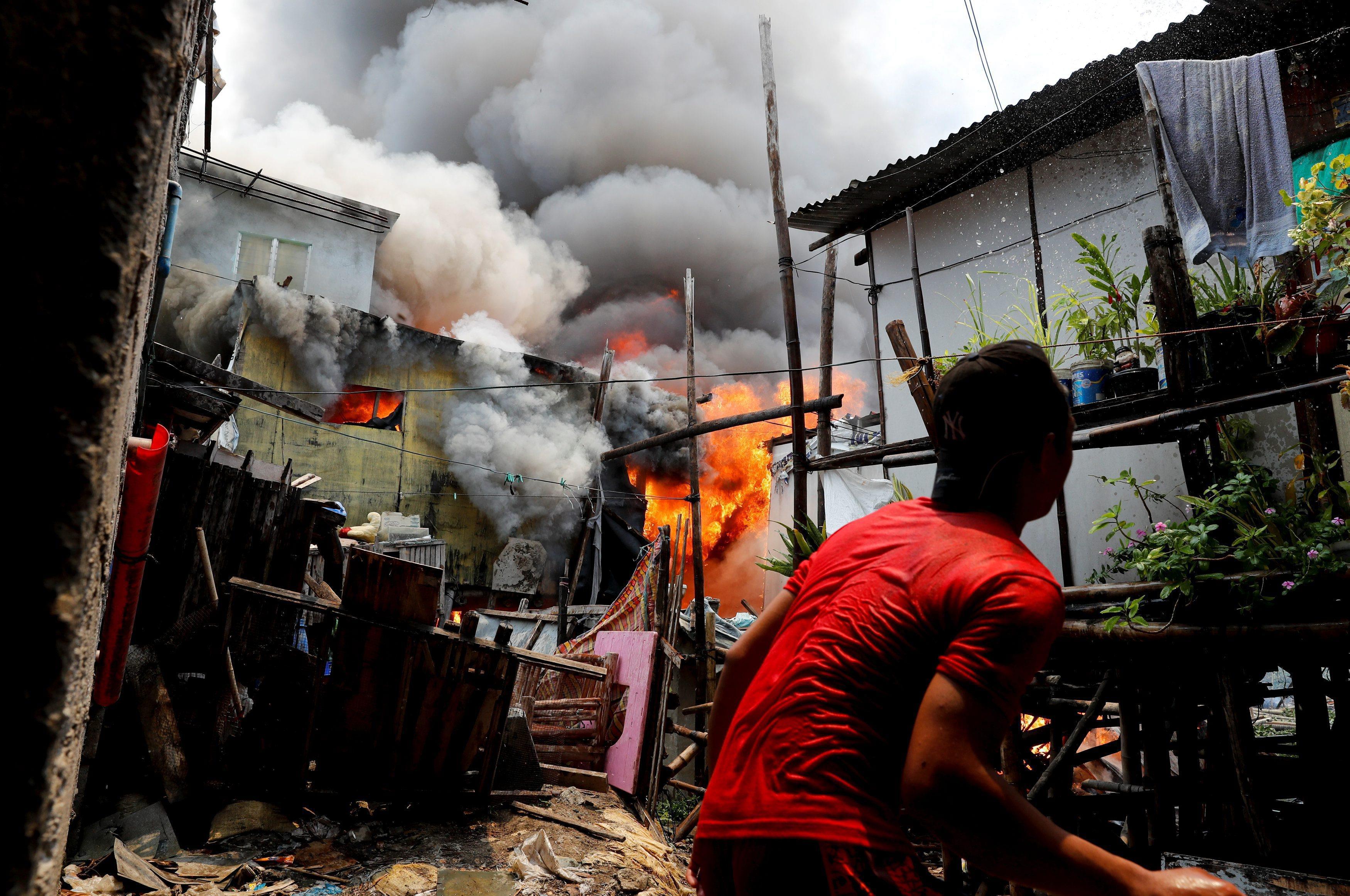 The Wider Image: Manila's slums an endless battle for firefighters
