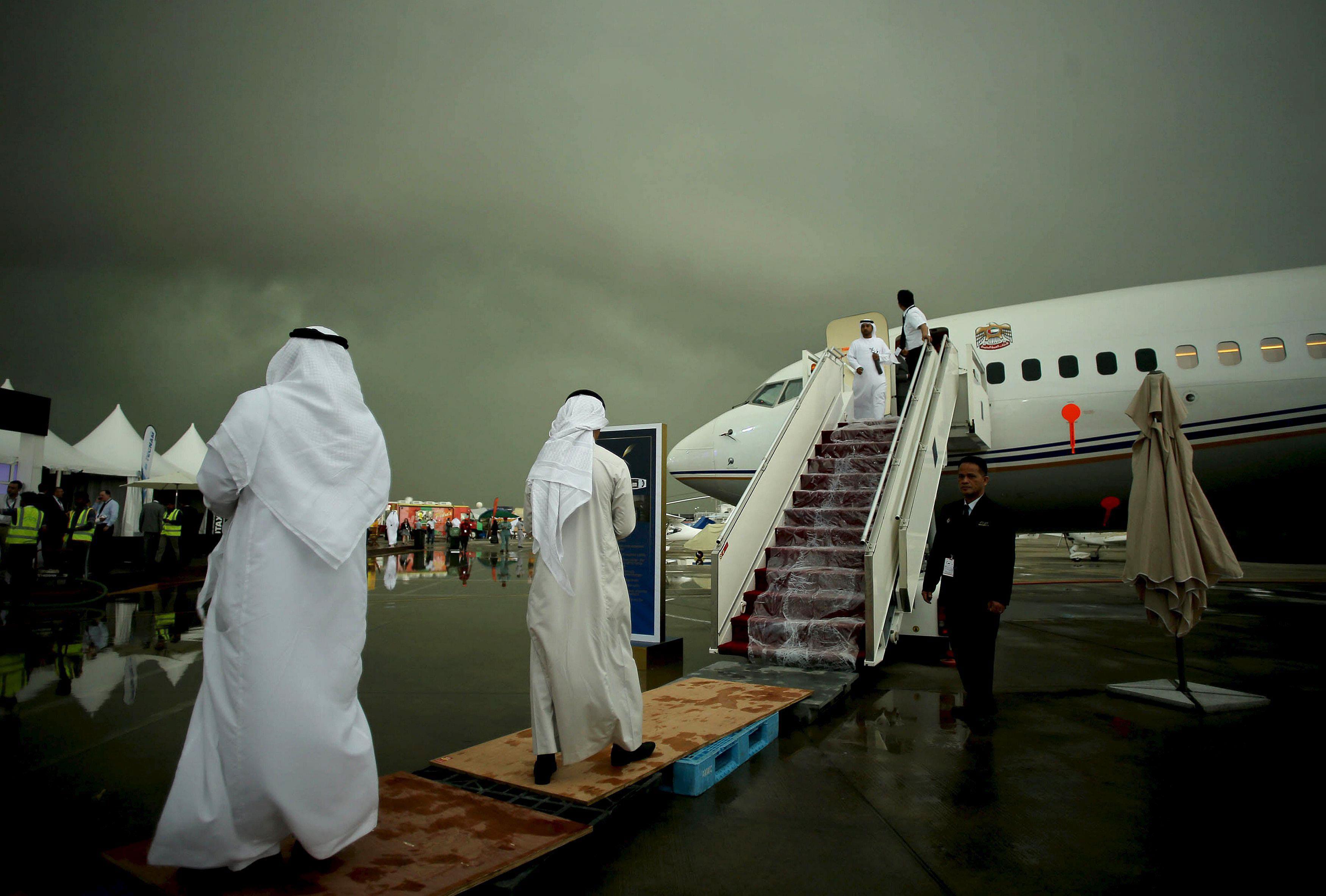 People stand at Al Bateen airport during a rainstorm in Abu Dhabi