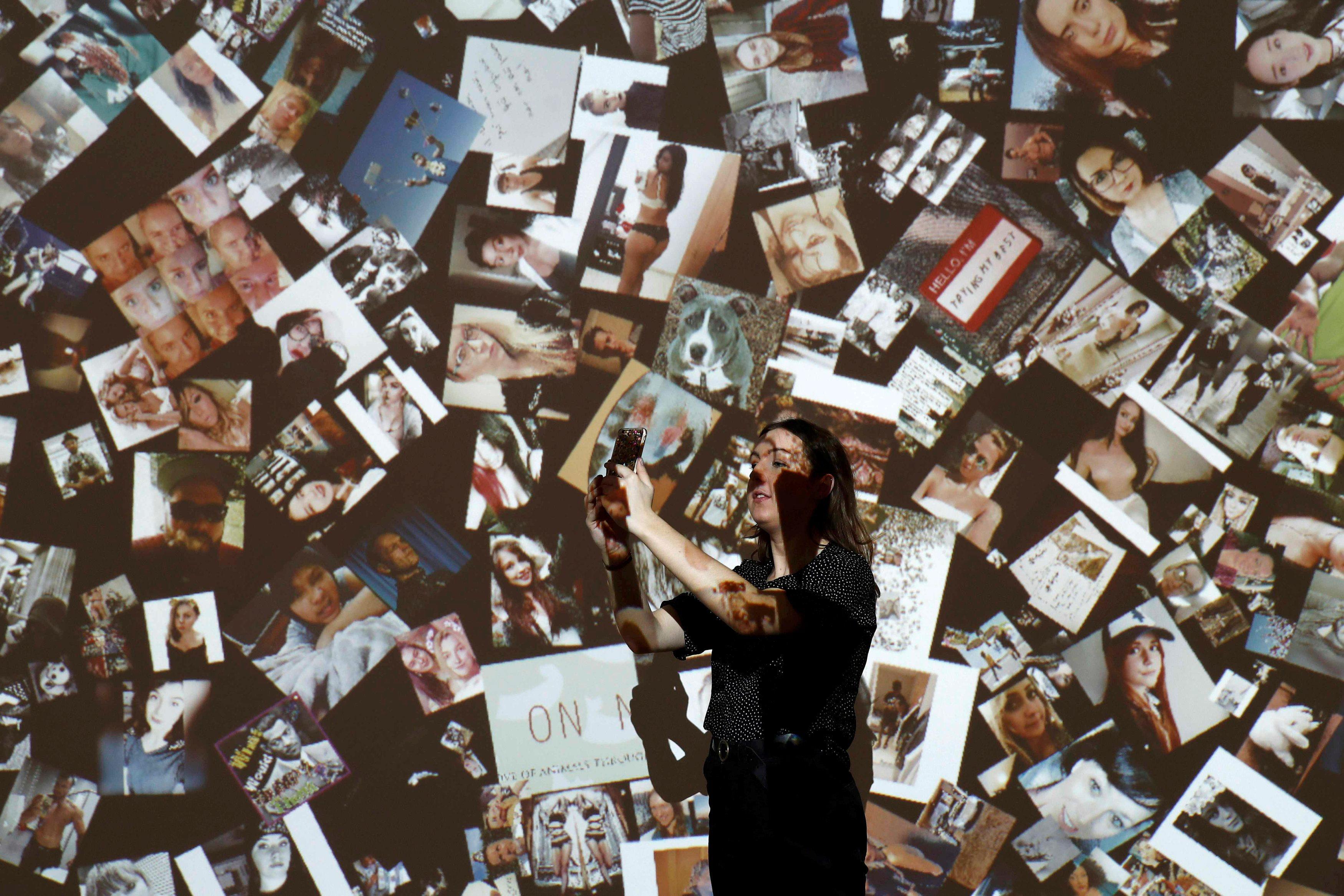 A gallery assistant poses for a photograph during a press day to promote the upcoming exhibition 'Fr