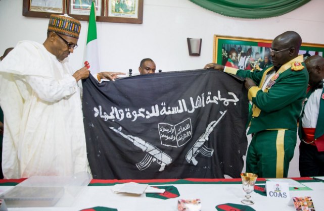 Army presents captured Boko Haram flag to President Muhammadu Buhari