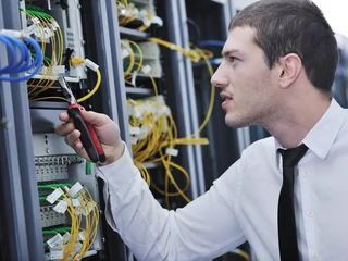 young engeneer in datacenter server room